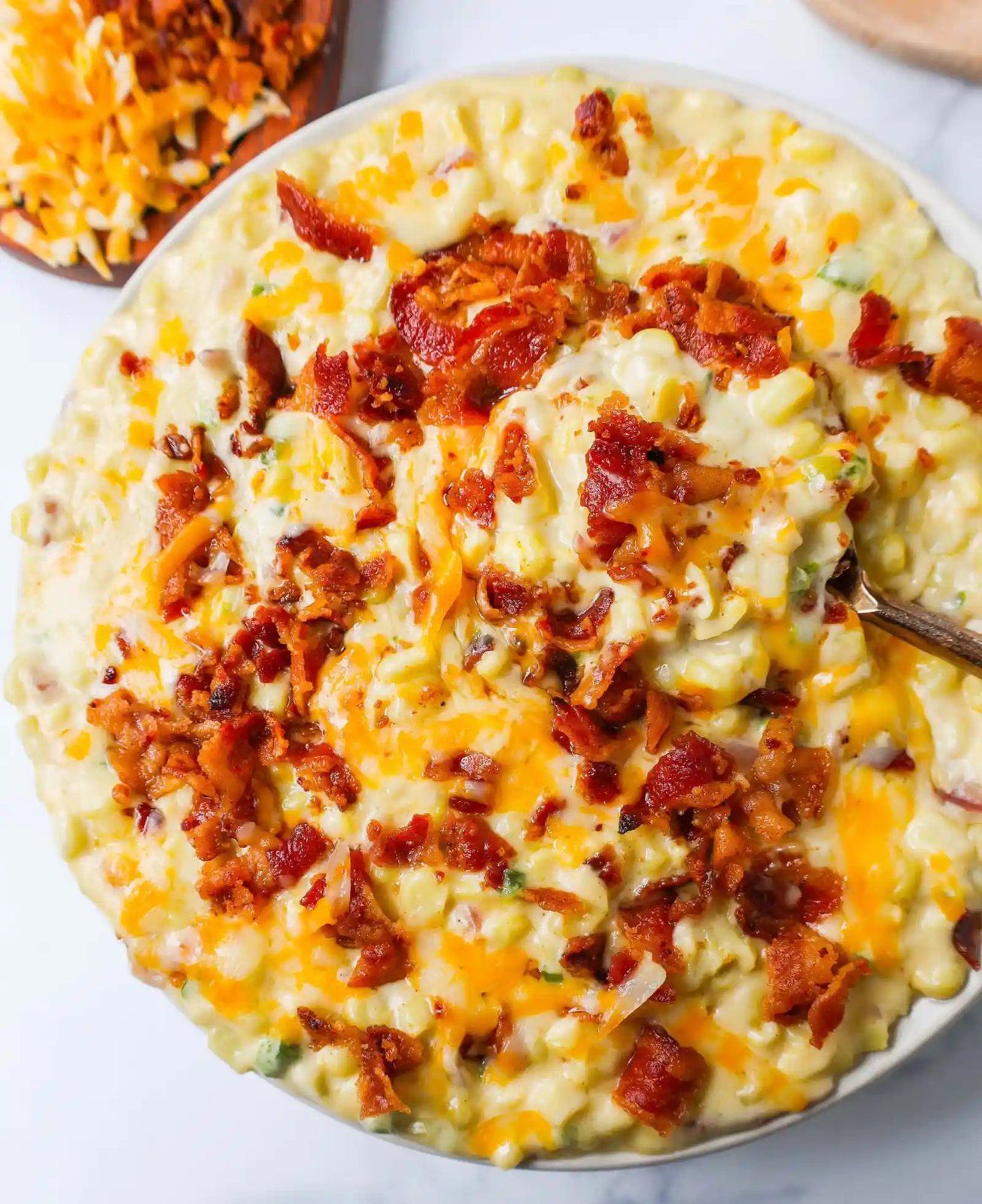 This homemade creamed corn with crispy bacon is the perfect easy side dish recipe. This is always the biggest hit at any dinner and the first vegetable side dish to be finished.