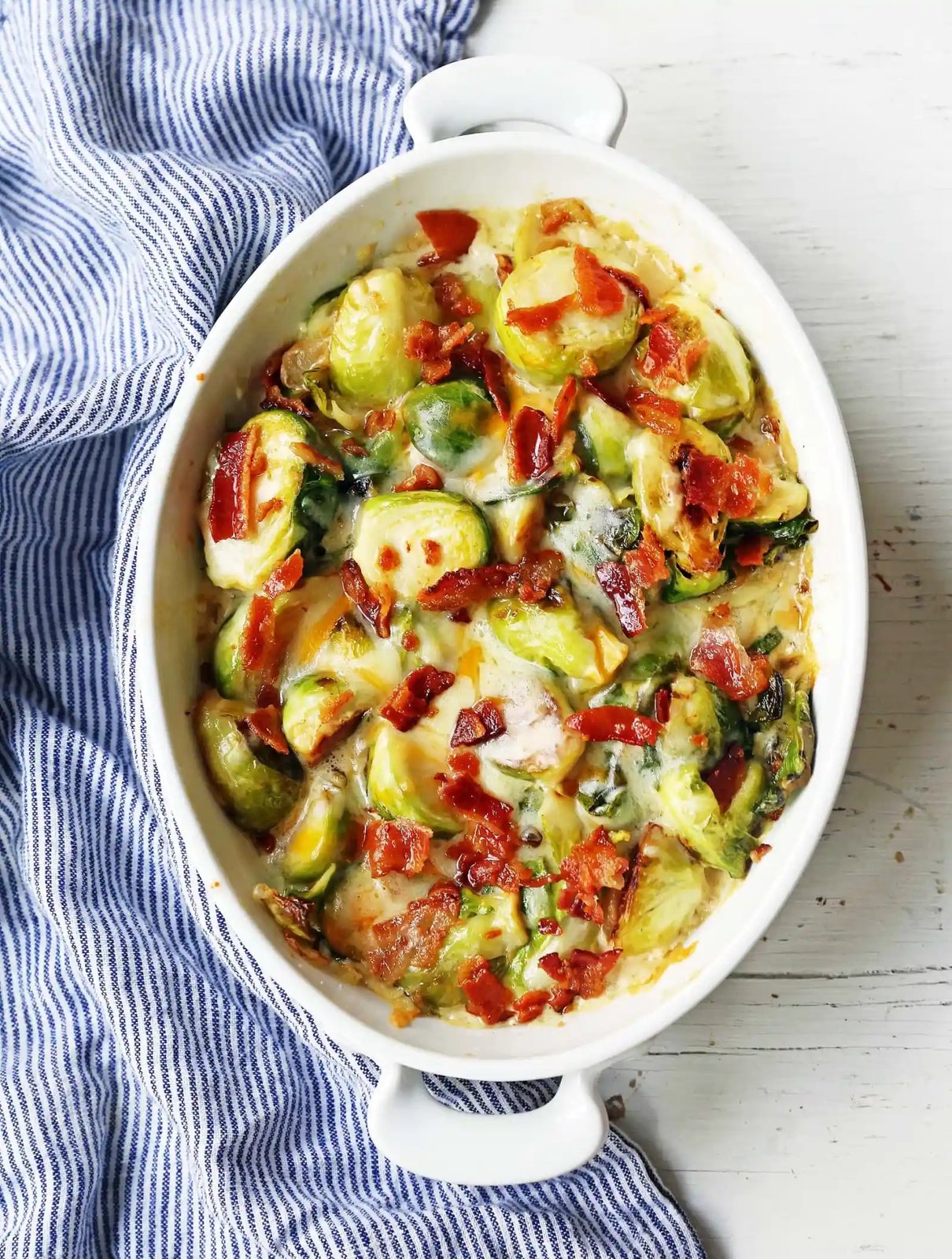 Creamy Cheesy Brussels Sprouts with Bacon. Roasted brussels sprouts with crispy bacon, a creamy sauce, and melted cheese. www.modernhoney.com #brusselsprouts #brusselsprouts #sidedish #vegetables