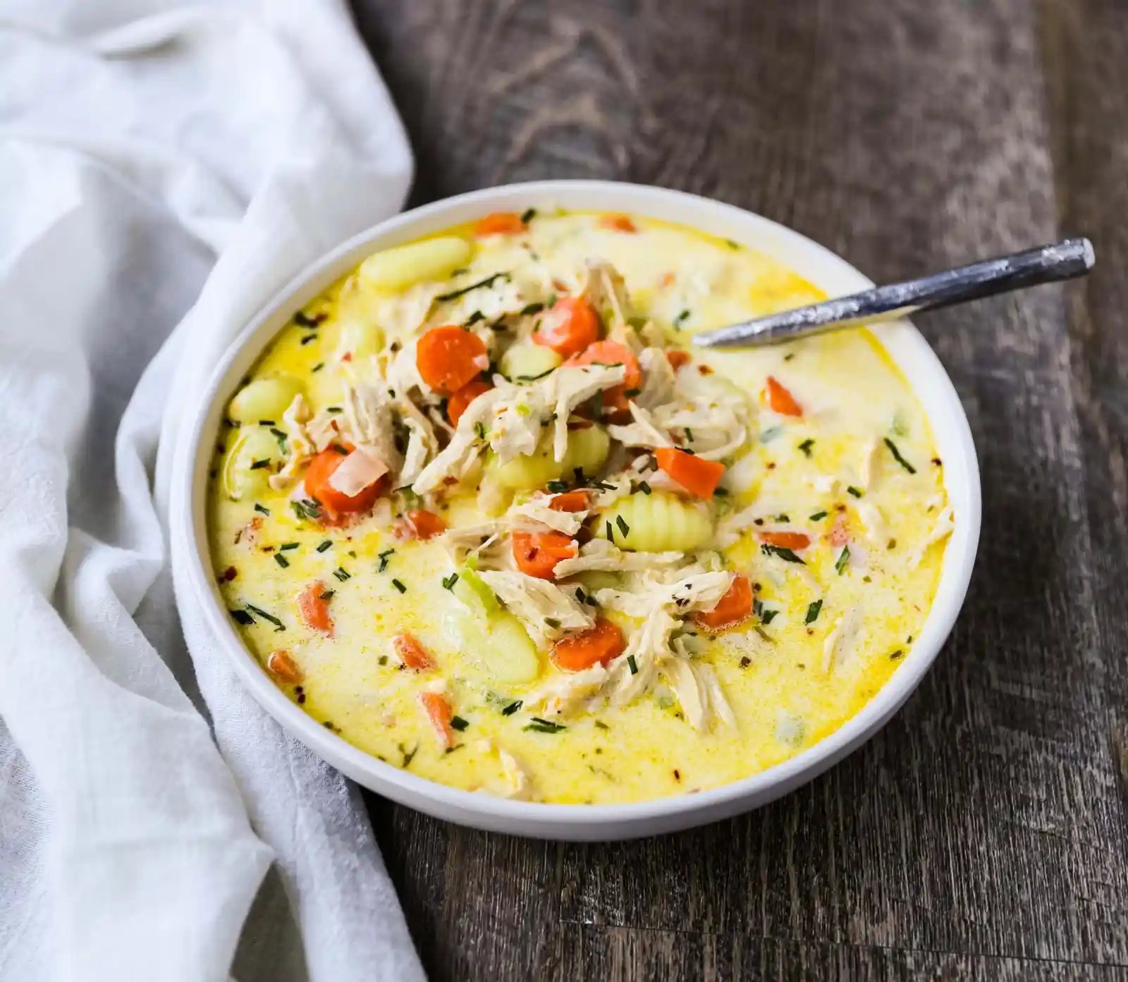 Creamy Gnocchi Chicken Soup Creamy chicken and vegetable soup with soft gnocchi pasta in a parmesan cheese creamy both. A warm, comforting bowl of comfort food! www.modernhoney.com #soup #soups #chickensoup