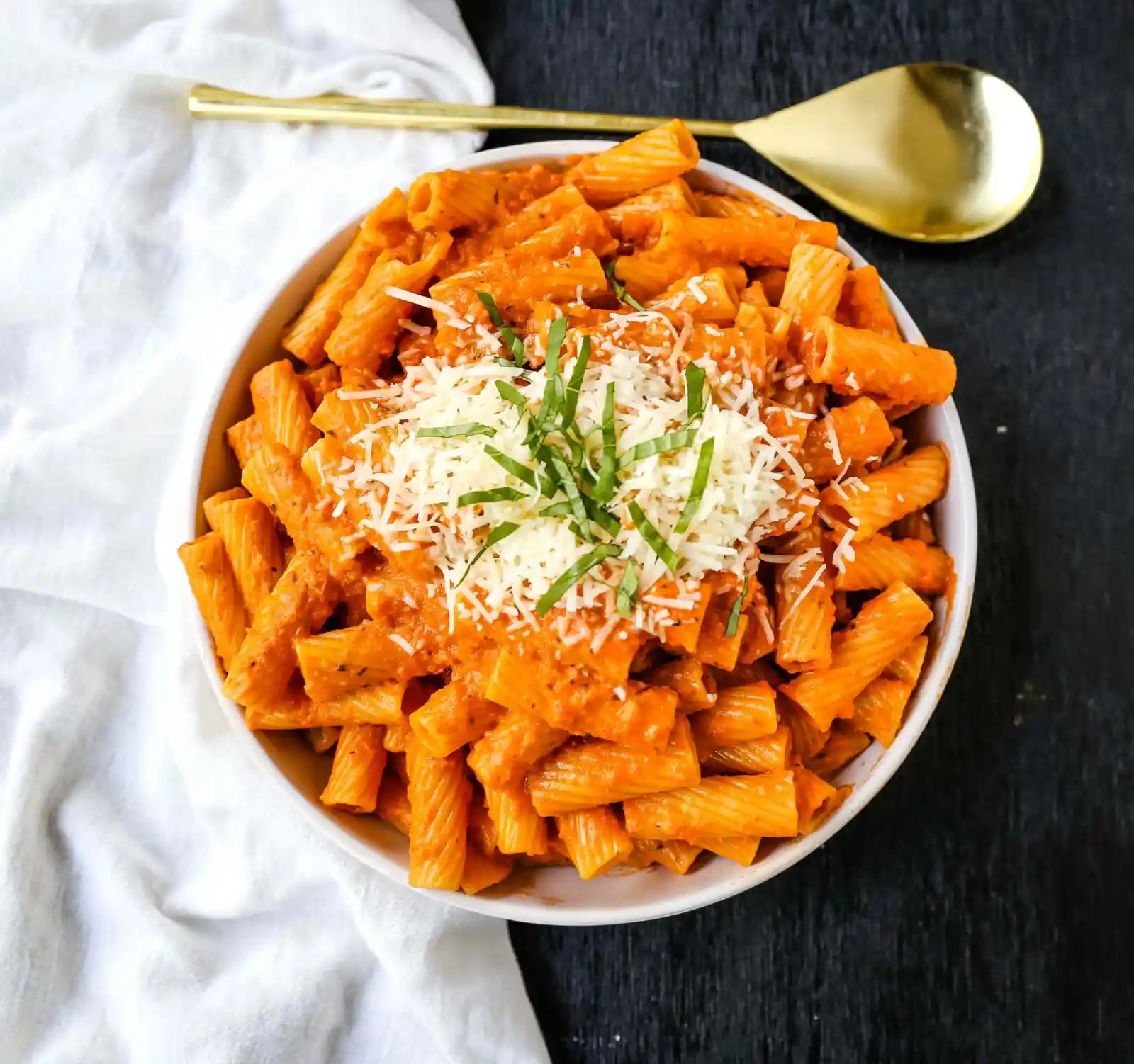 Creamy Roasted Red Pepper Pasta A creamy roasted red pepper and tomato basil sauce with garlic and heavy cream all tossed together with pasta and topped with parmesan cheese. A flavorful robust pasta dish! www.modernhoney.com #pasta #italian #italianfood