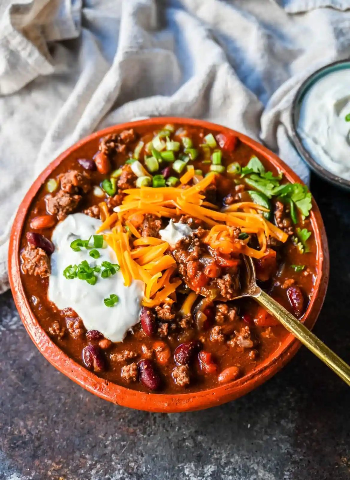 Crockpot Beef Chili. This slow cooker beef chili is the ultimate comforting meal, made even better with a surprising secret ingredient! This crockpot beef chili will be surefire hit and you'll be hooked on how the sweetness and spices come together to create the best crockpot chili.