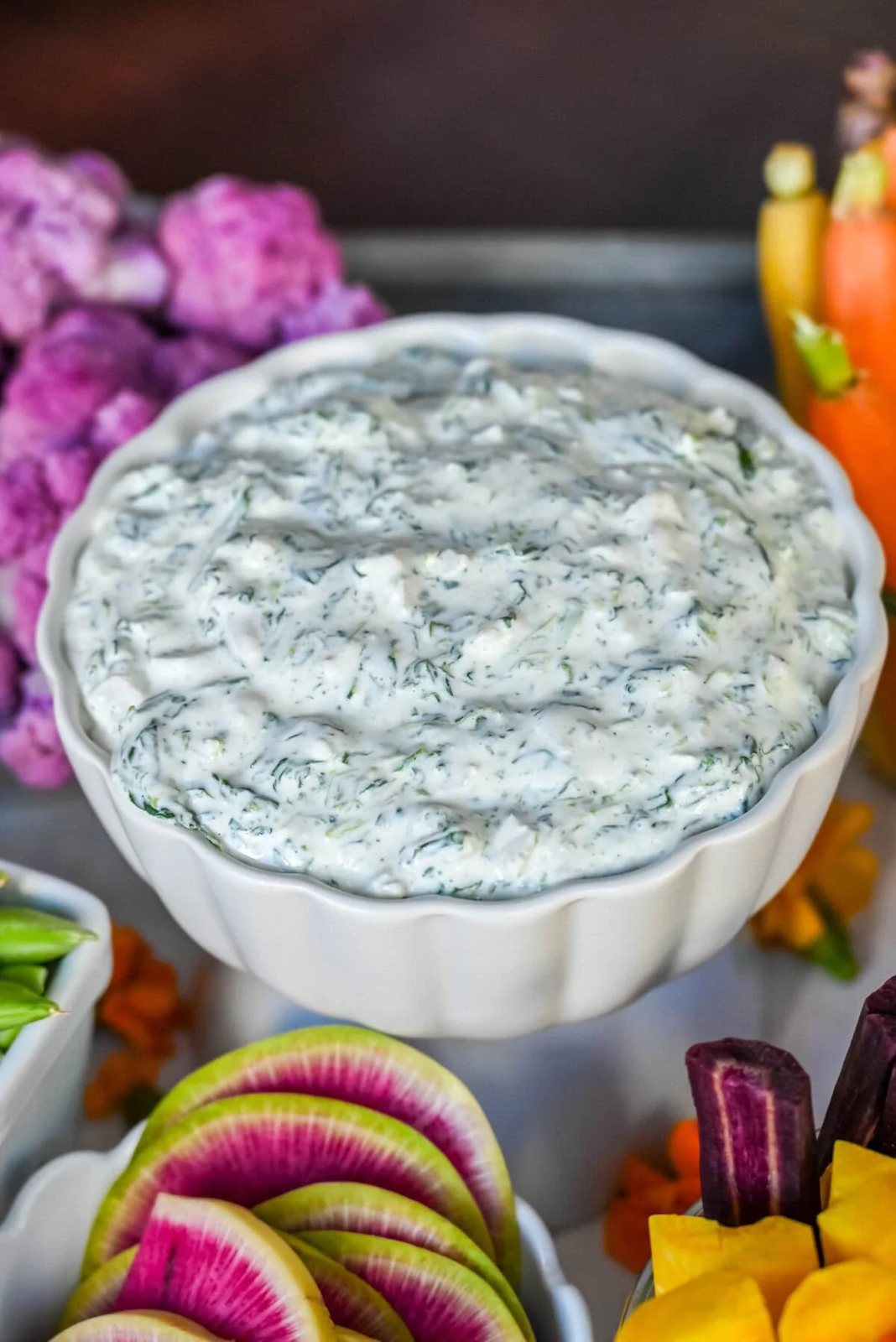 Homemade cold spinach dip on a crudite platter or vegetable board