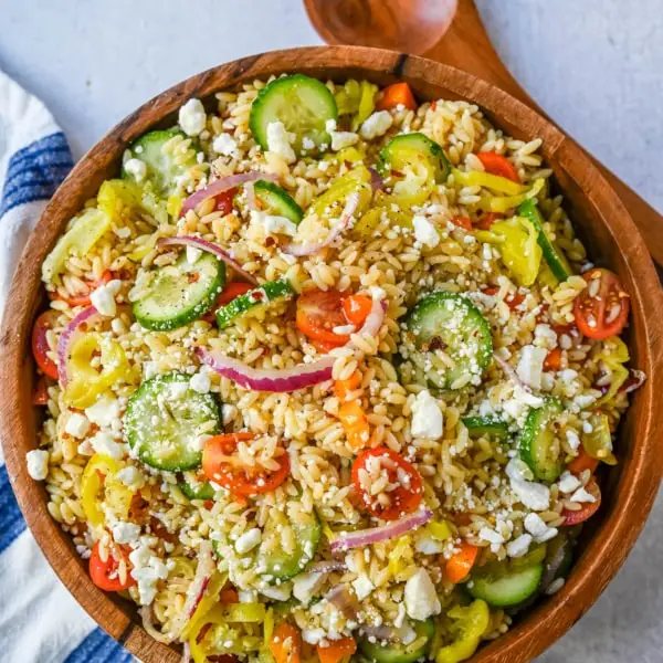 Fresh Mediterranean Orzo Salad made with a bright greek oregano dressing, orzo pasta, crisp cucumber, cherry tomatoes, red onion, feta cheese, and pepperoncinis. This greek orzo pasta salad recipe is perfect for summer or meal prep!