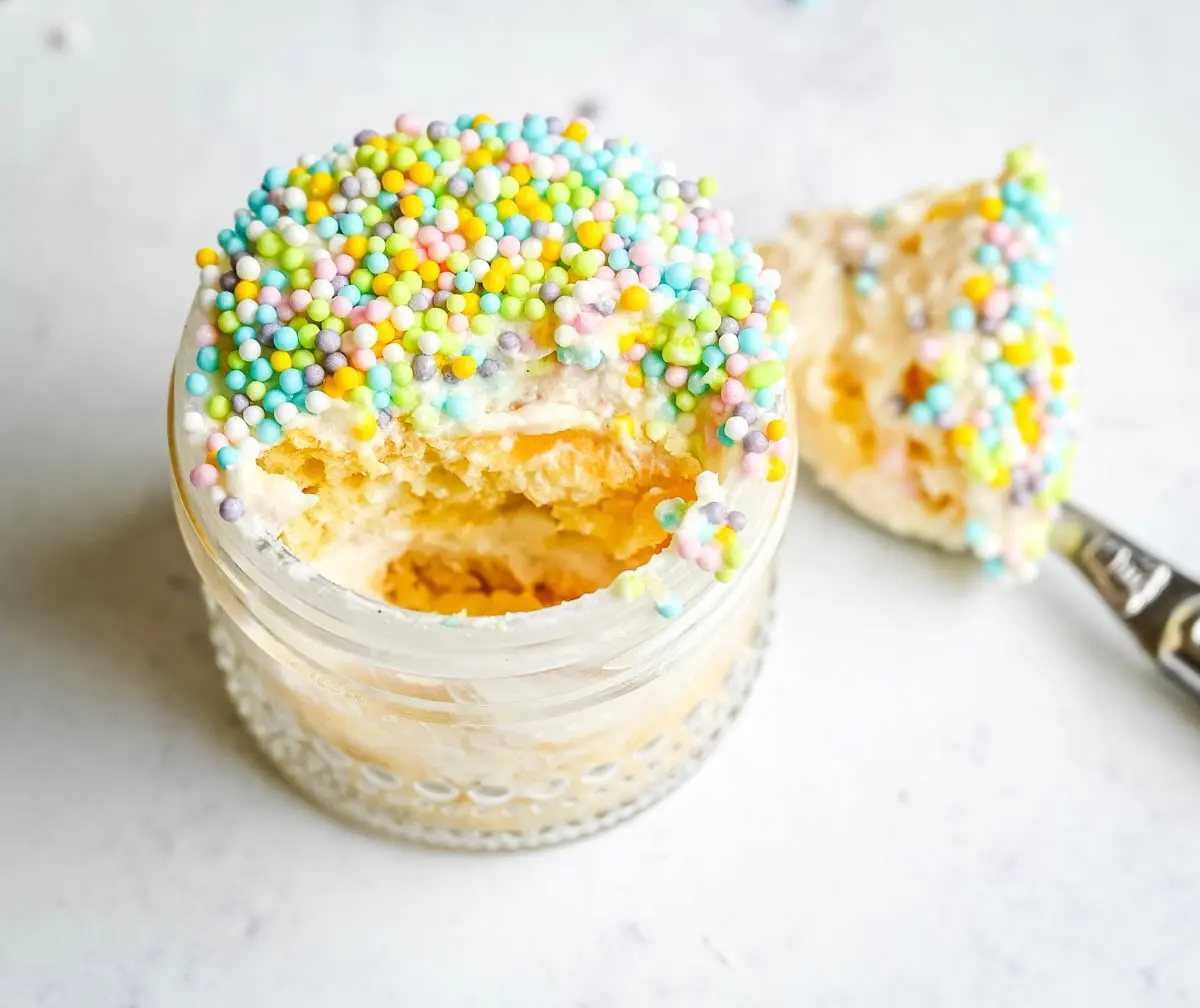 This viral dot cake recipe brings the NYC sprinkle cake trend straight to your kitchen — no trip to Butterfield Market required! Soft, buttery homemade yellow cake layered in a cup, topped with creamy vanilla buttercream, and completely coated in rainbow nonpareil sprinkles for that irresistible crunch. This easy homemade version is better than any boxed mix recipe you'll find — and takes less than an hour to make!