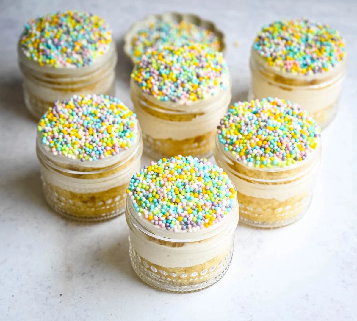 Dot Cake Recipe (Cake in a jar). This viral dot cake recipe brings the NYC sprinkle cake trend straight to your kitchen — no trip to Butterfield Market required! Soft, buttery homemade yellow cake layered in a cup, topped with creamy vanilla buttercream, and completely coated in rainbow nonpareil sprinkles for that irresistible crunch. This easy homemade version is better than any boxed mix recipe you'll find — and takes less than an hour to make!