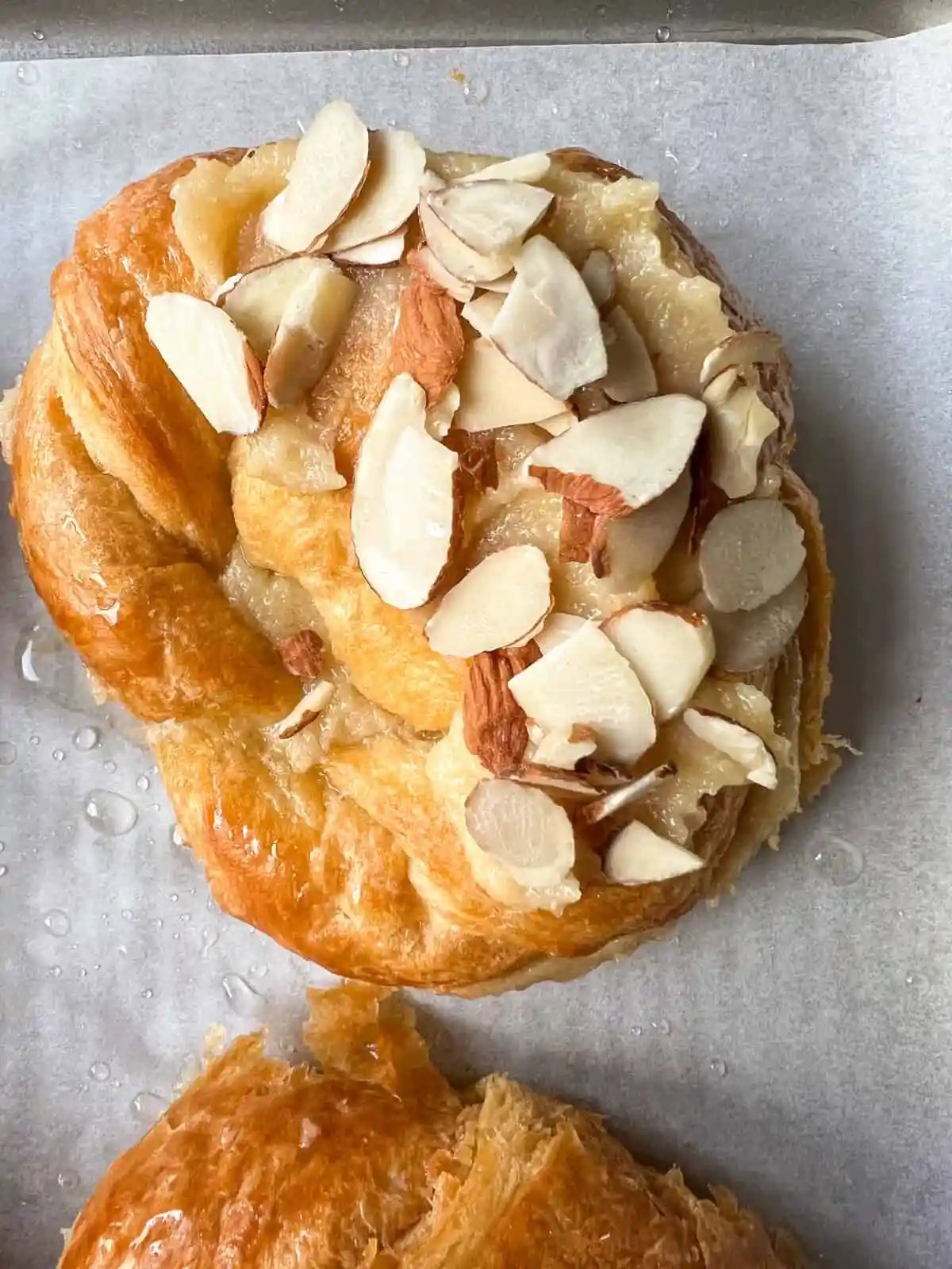 Easy Almond Croissants. How to make the easiest homemade almond croissants ever! These buttery, flaky croissants filled with a homemade almond filling and topped with crunchy almonds will rival any bakery. You can make these bakery-style almond croissants in 25 minutes!