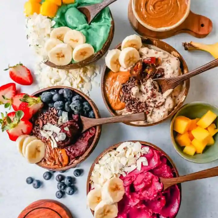 How to make a thick, creamy, fruity smoothie bowl at home. Here are all of the tips and tricks for making the best smoothie bowls. I am sharing 4 smoothie bowl recipes -- acai smoothie bowl, pitaya dragonfruit smoothie bowl, chocolate peanut butter banana smoothie bowl, and tropical pineapple coconut smoothie bowl.