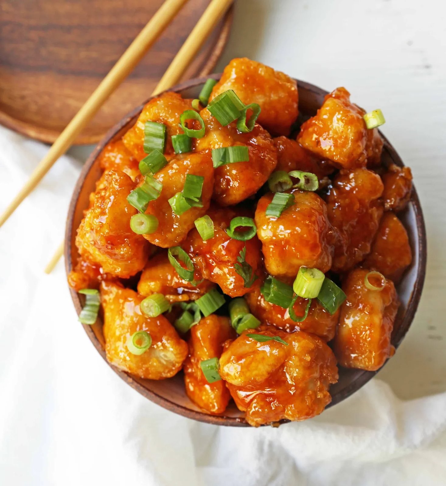 Firecracker Chicken. Sweet and spicy chicken bites made with tender chicken, flash-fried, and baked in a sweet brown sugar buffalo sauce. You'll have people coming back for seconds in no time at all! www.modernhoney.com #firecrackerchicken #buffalochicken #chicken #chickenbites