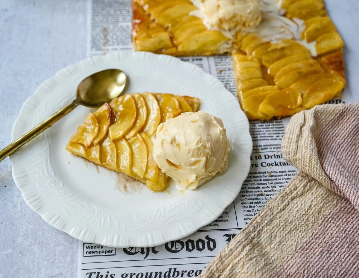 This homemade French Apple Tart recipe features a buttery crust, thinly sliced Granny Smith apples, and a golden apricot glaze for a bakery-style dessert. This Ina Garten French Apple Tart recipe is the best apple tart recipe, perfect for entertaining, holidays or any Fall baking.