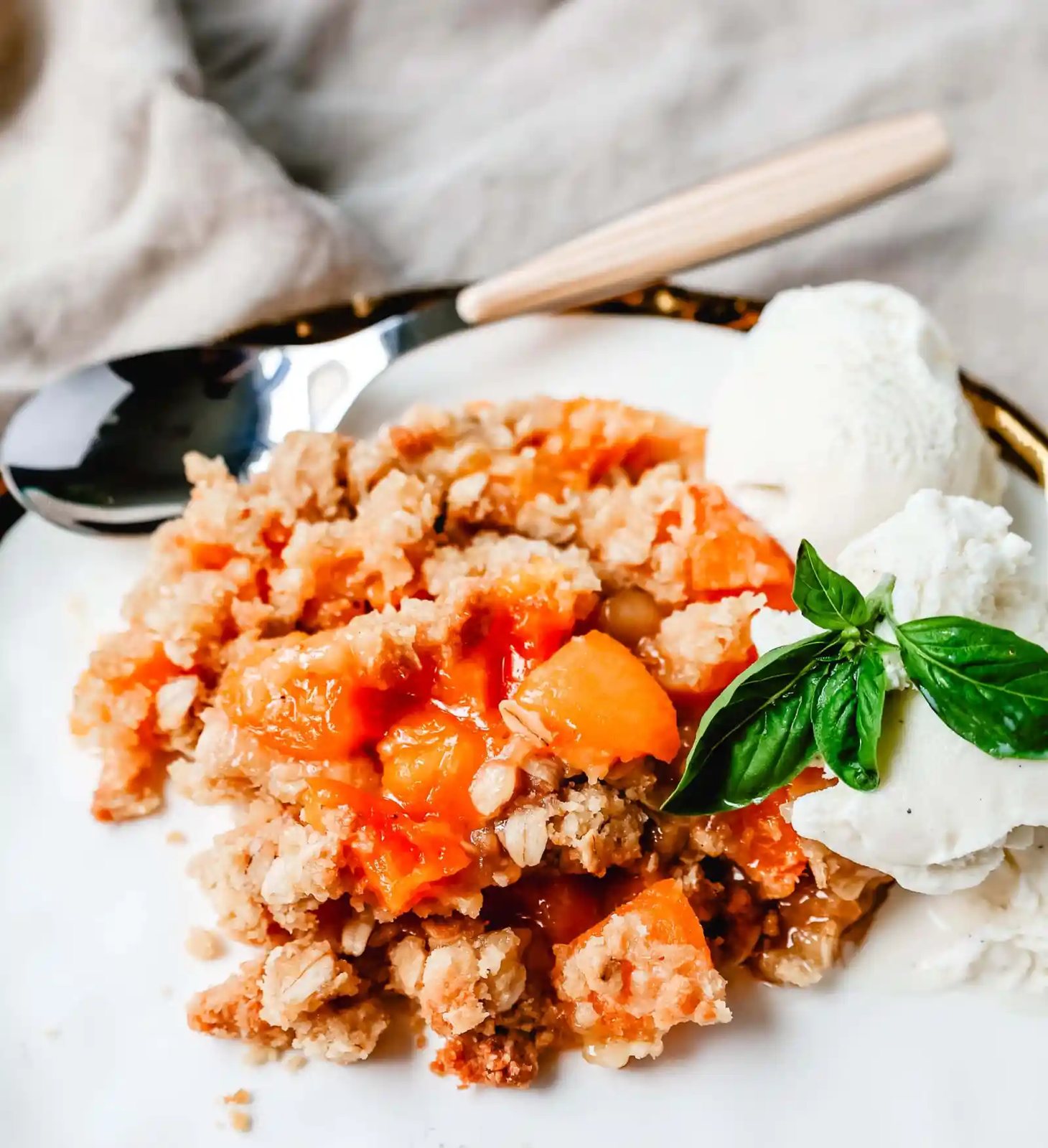 This Apricot Crisp is made with fresh apricots tossed in sugar and almond extract and topped with a homemade brown sugar oat crumble. This rustic summer dessert is served with a big scoop of vanilla bean ice cream.