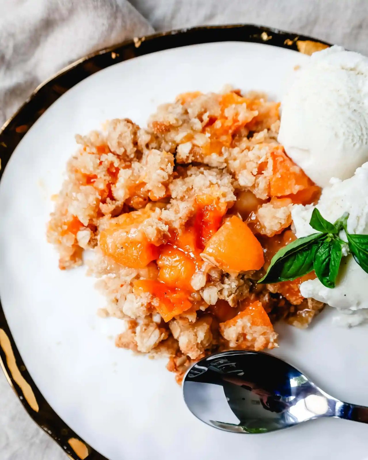 This Apricot Crisp is made with fresh apricots tossed in sugar and almond extract and topped with a homemade brown sugar oat crumble. This rustic summer dessert is served with a big scoop of vanilla bean ice cream.