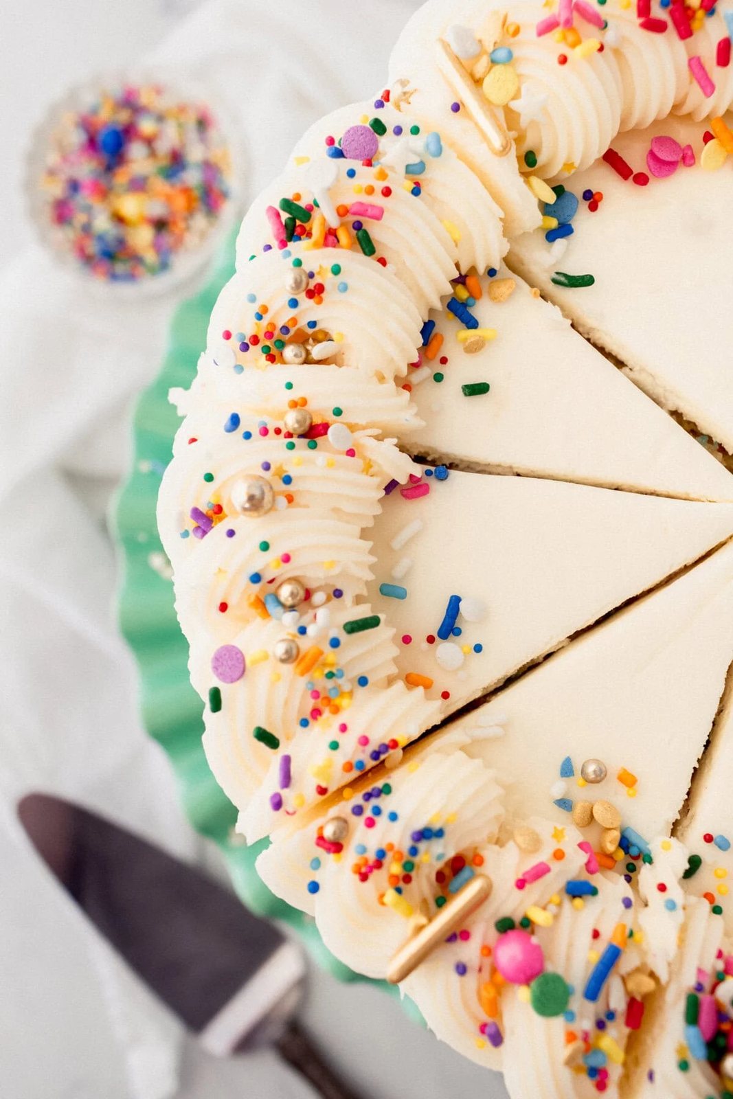 A layered funfetti or confetti cake with sprinkles. A fluffy homemade Funfetti birthday cake with rainbow sprinkles topped with a light cream cheese buttercream frosting and an array of sprinkles. This Confetti Cake recipe is the perfect birthday cake!