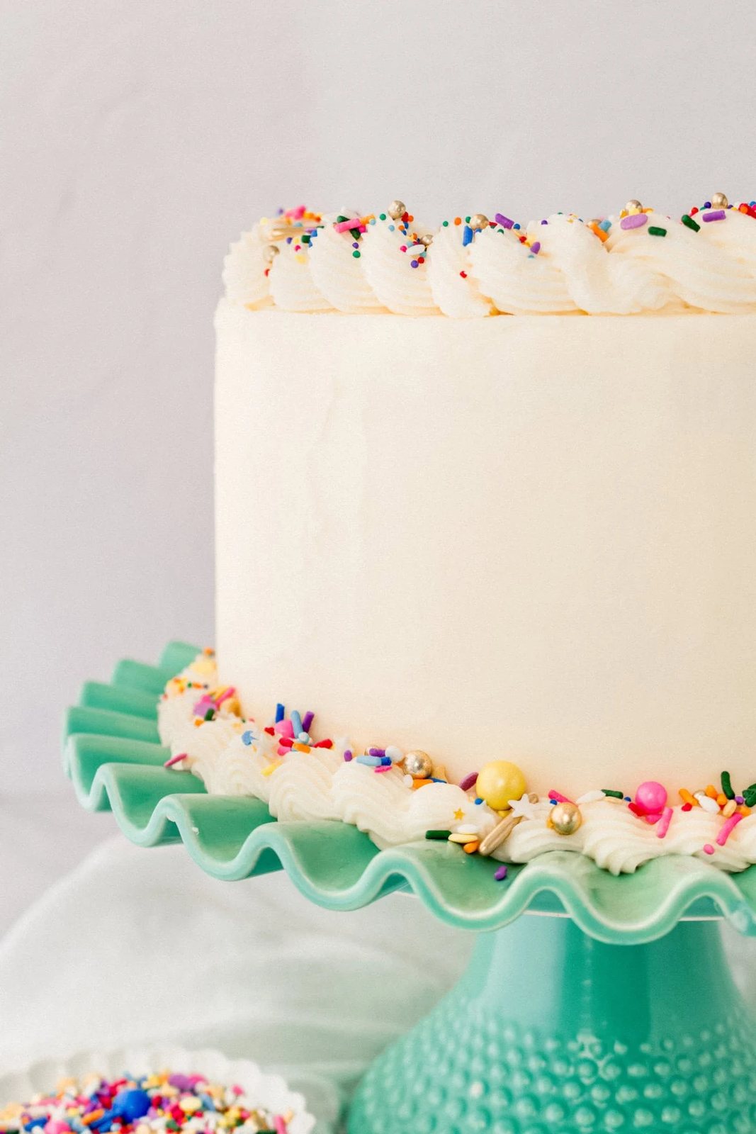 A layered funfetti or confetti cake with sprinkles. A fluffy homemade Funfetti birthday cake with rainbow sprinkles topped with a light cream cheese buttercream frosting and an array of sprinkles. This Confetti Cake recipe is the perfect birthday cake!