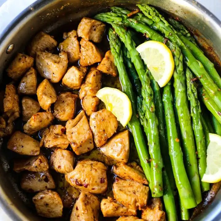 Garlic Butter Chicken and Asparagus Skillet A quick and easy one skillet dinner made with sautéed chicken and asparagus tossed in garlic butter. www.modernhoney.com #chicken #skilletdinner #chickendinner