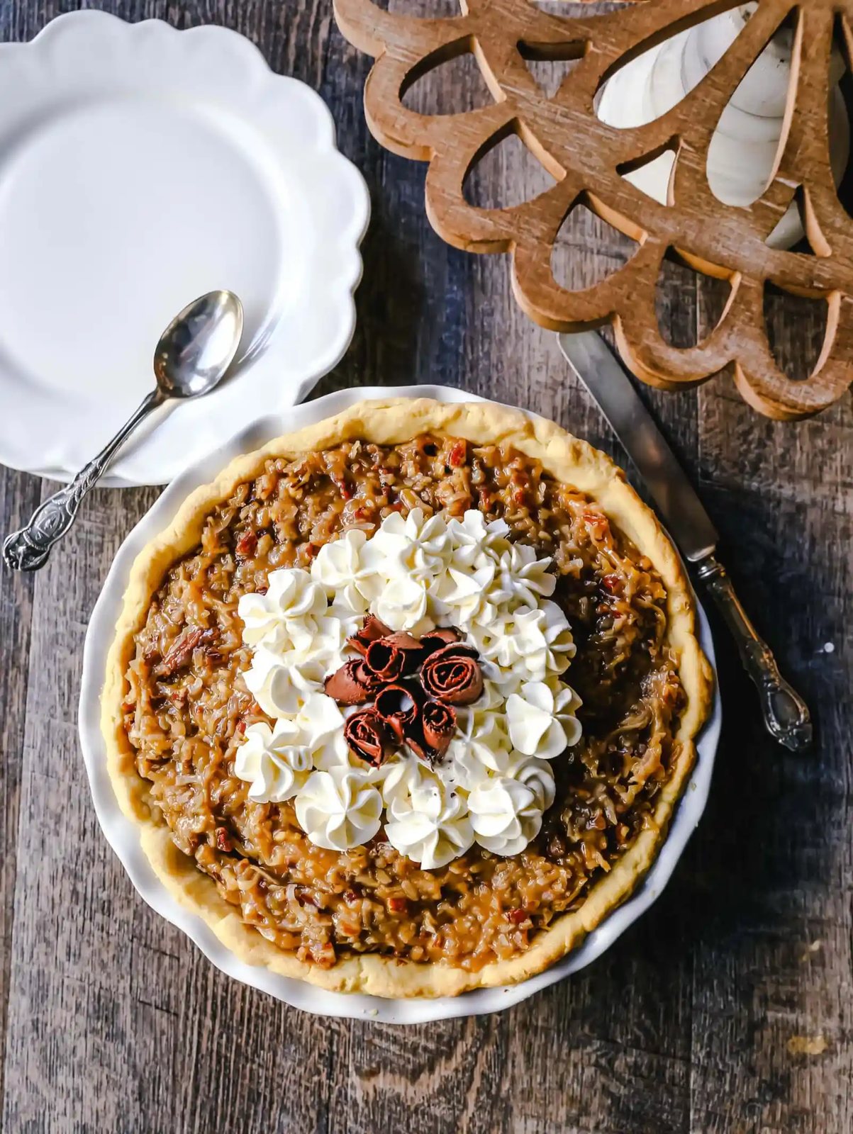 German Chocolate Pie. Creamy rich chocolate pie with a sticky German chocolate coconut-pecan topping and fresh whipped cream and chocolate shavings. www.modernhoney.com #pie #chocolatepie #germanchocolate
