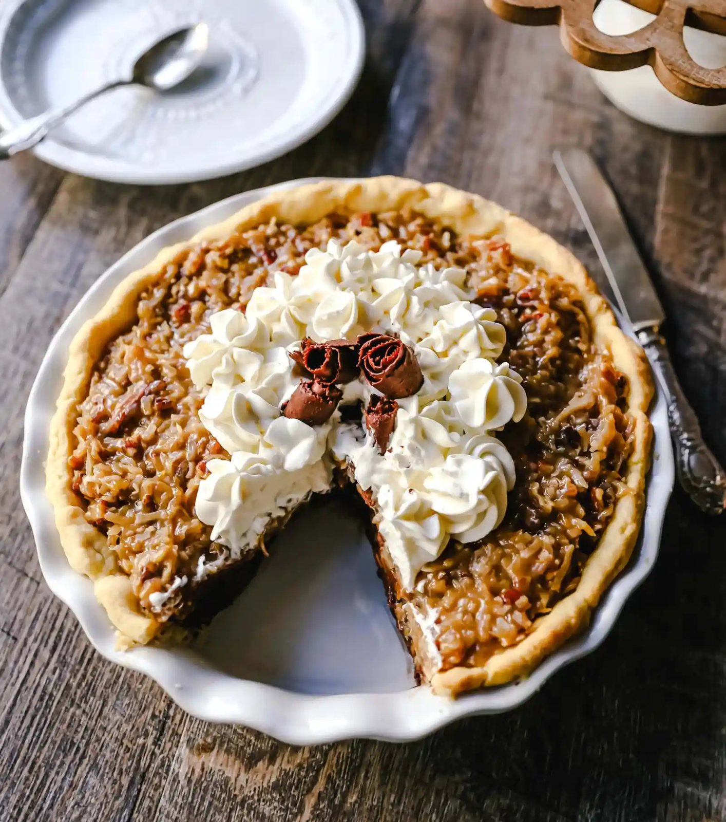 German Chocolate Pie. Creamy rich chocolate pie with a sticky German chocolate coconut-pecan topping and fresh whipped cream and chocolate shavings. www.modernhoney.com #pie #chocolatepie #germanchocolate