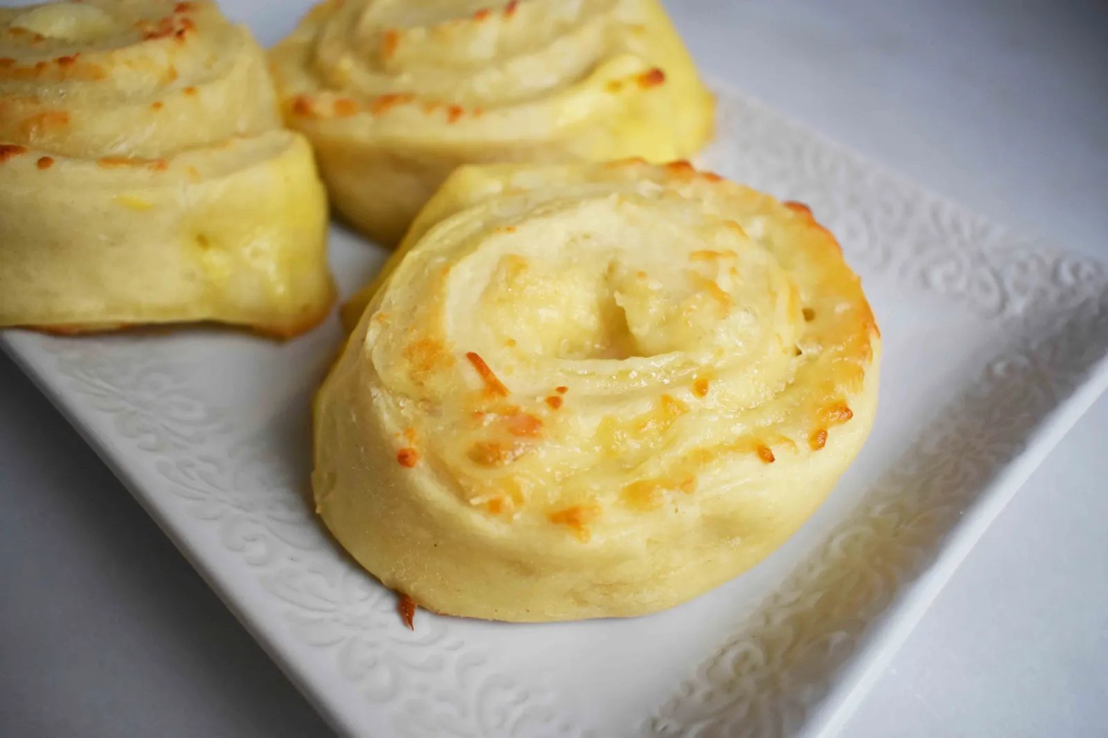 Golden's Garlic Parmesan Cheese Rolls by Modern Honey. Made with 5 simple ingredients -- pizza dough, butter, garlic powder, parmesan and mozzarella cheese.