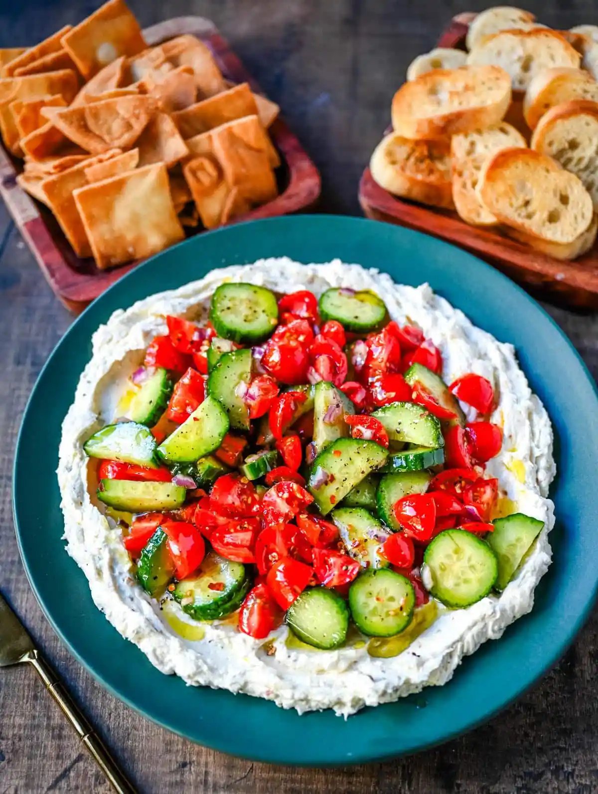 This Greek feta dip is the ultimate party and holiday appetizer that is rich, creamy, and so flavorful! It blends tangy feta, cream cheese, lemon, oregano, and olive oil into a silky whipped dip that feels fancy but takes just minutes to make. Pile it high with tomatoes, cucumbers, and a drizzle of olive oil, then serve with pita chips or veggies.