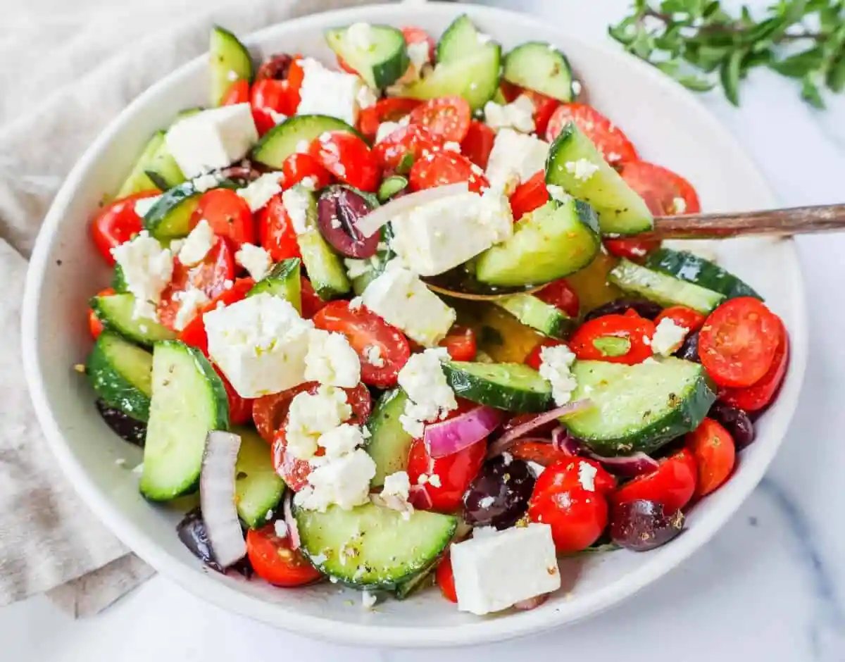 This simple Greek Salad is made with fresh tomatoes, cucumbers, red onion, kalamata olives, feta cheese, and all tossed with a homemade tangy Greek dressing.