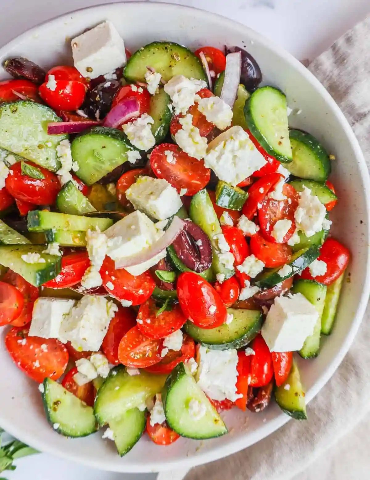 This simple Greek Salad is made with fresh tomatoes, cucumbers, red onion, kalamata olives, feta cheese, and all tossed with a homemade tangy Greek dressing.