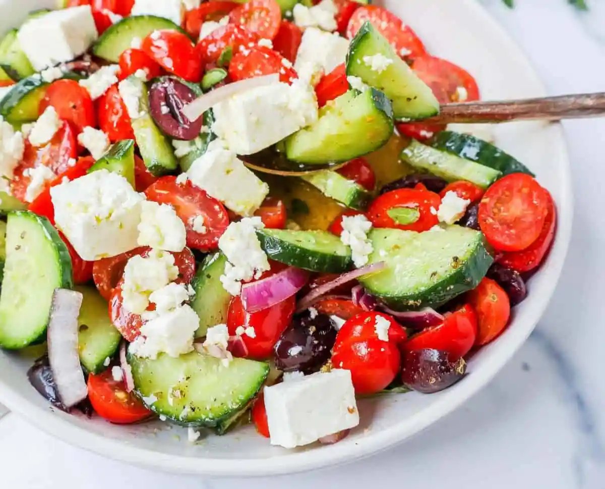 This simple Greek Salad is made with fresh tomatoes, cucumbers, red onion, kalamata olives, feta cheese, and all tossed with a homemade tangy Greek dressing.