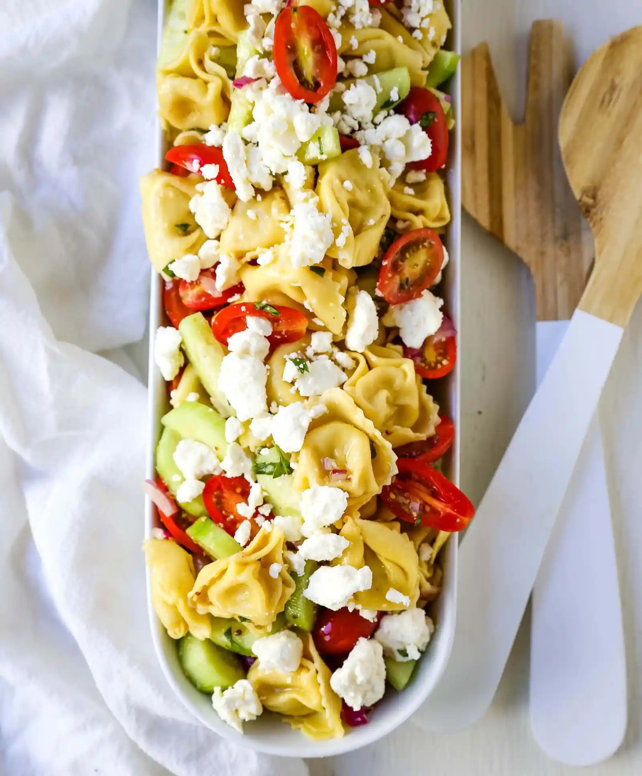 Greek Tortellini Pasta Salad. Cheese Tortellini Pasta tossed with fresh tomatoes, cucumbers, red onion, feta cheese, in a homemade Greek dressing. www.modernhoney.com #sidedish #pastasalad #salad #potluck
