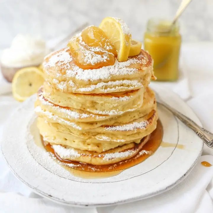 Lemon Ricotta Pancakes Creamy, fluffy lemon ricotta pancakes made with fresh ricotta, buttermilk, fresh lemon zest, and juice. A mix between a pancake and a crepe with a melt-in-your-mouth soft texture. www.modernhoney.com #pancakes #lemonricottapancakes #brunch #breakfast