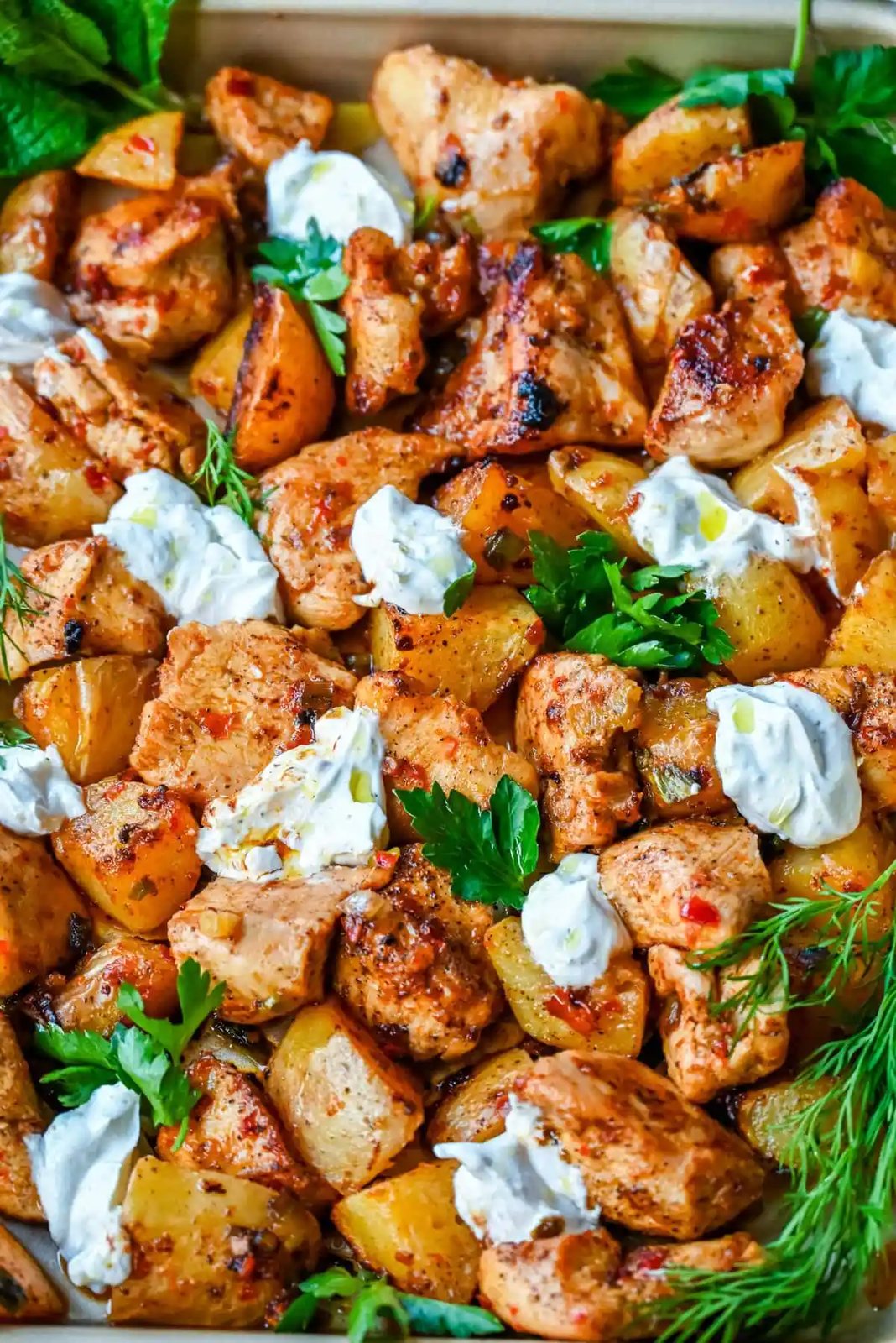 This Harissa Chicken and Roasted Potatoes recipe is a flavorful one-pan meal with juicy chicken breasts coated in a spicy harissa sauce and roasted with golden potatoes until perfectly crispy. A sprinkle of herbs at the end brings balance to this North African–inspired dish. It’s easy, satisfying, and the perfect simple weeknight dinner!