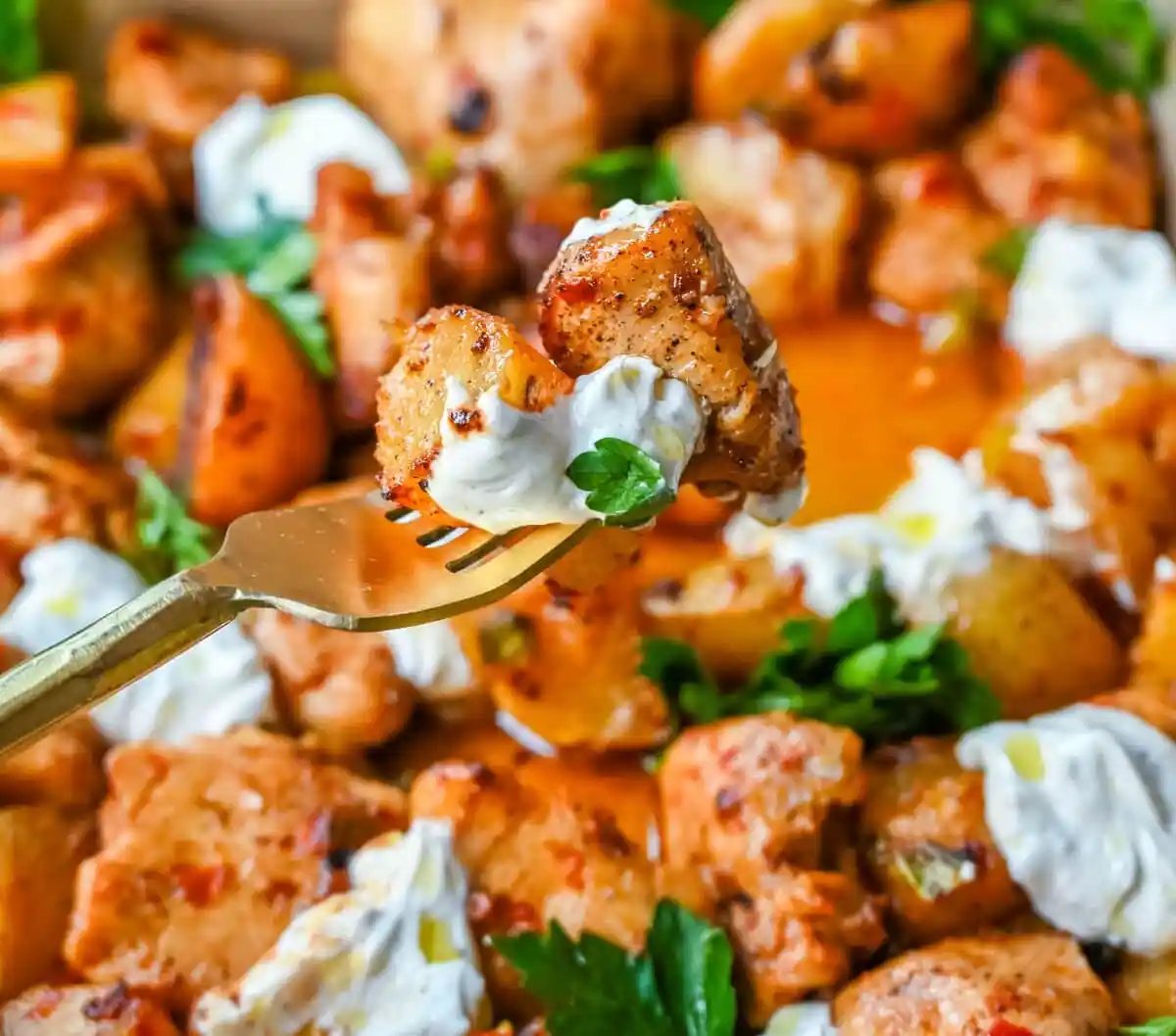 This Harissa Chicken and Roasted Potatoes recipe is a flavorful one-pan meal with juicy chicken breasts coated in a spicy harissa sauce and roasted with golden potatoes until perfectly crispy. A sprinkle of herbs at the end brings balance to this North African–inspired dish. It’s easy, satisfying, and the perfect simple weeknight dinner!