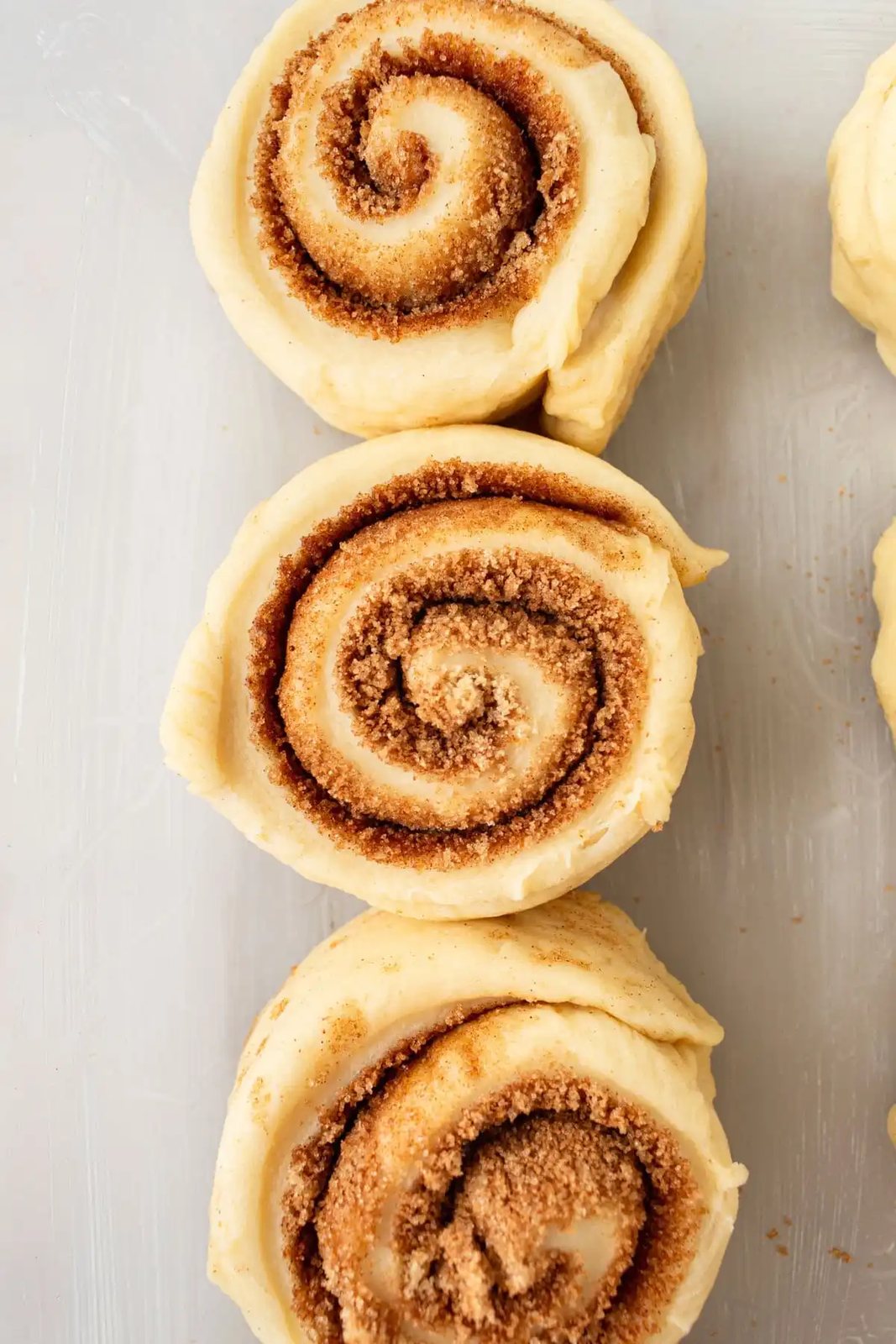 Cut out cinnamon roll dough into cinnamon rolls.