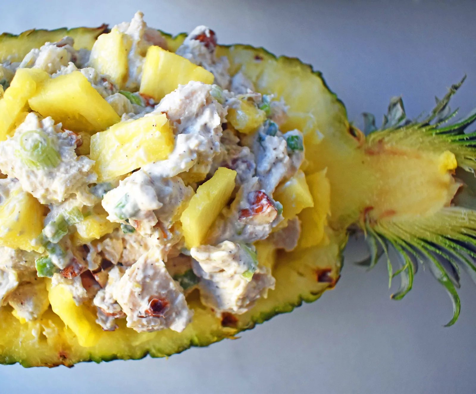 Healthy Tropical Chicken Salad made with lean chicken breast, greek yogurt, fresh pineapple, almonds, green onions, and spices. A high-protein lunch. www.modernhoney.com