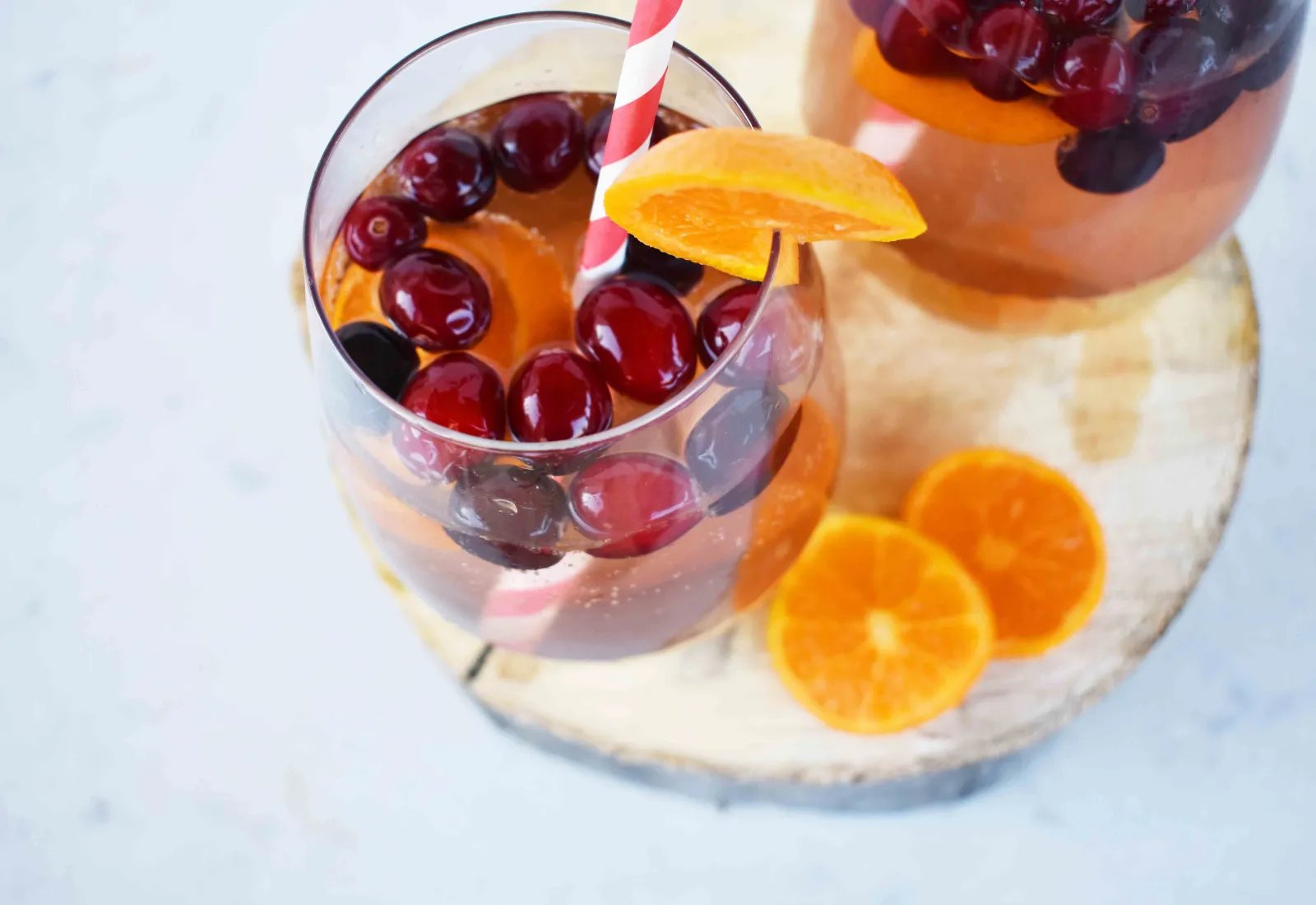 "The Henry" Cranberry Orange Mocktail by Modern Honey. Cranberry Sprite, Vanilla, Fresh Oranges and Cranberries. A perfect non-alcoholic party drink.