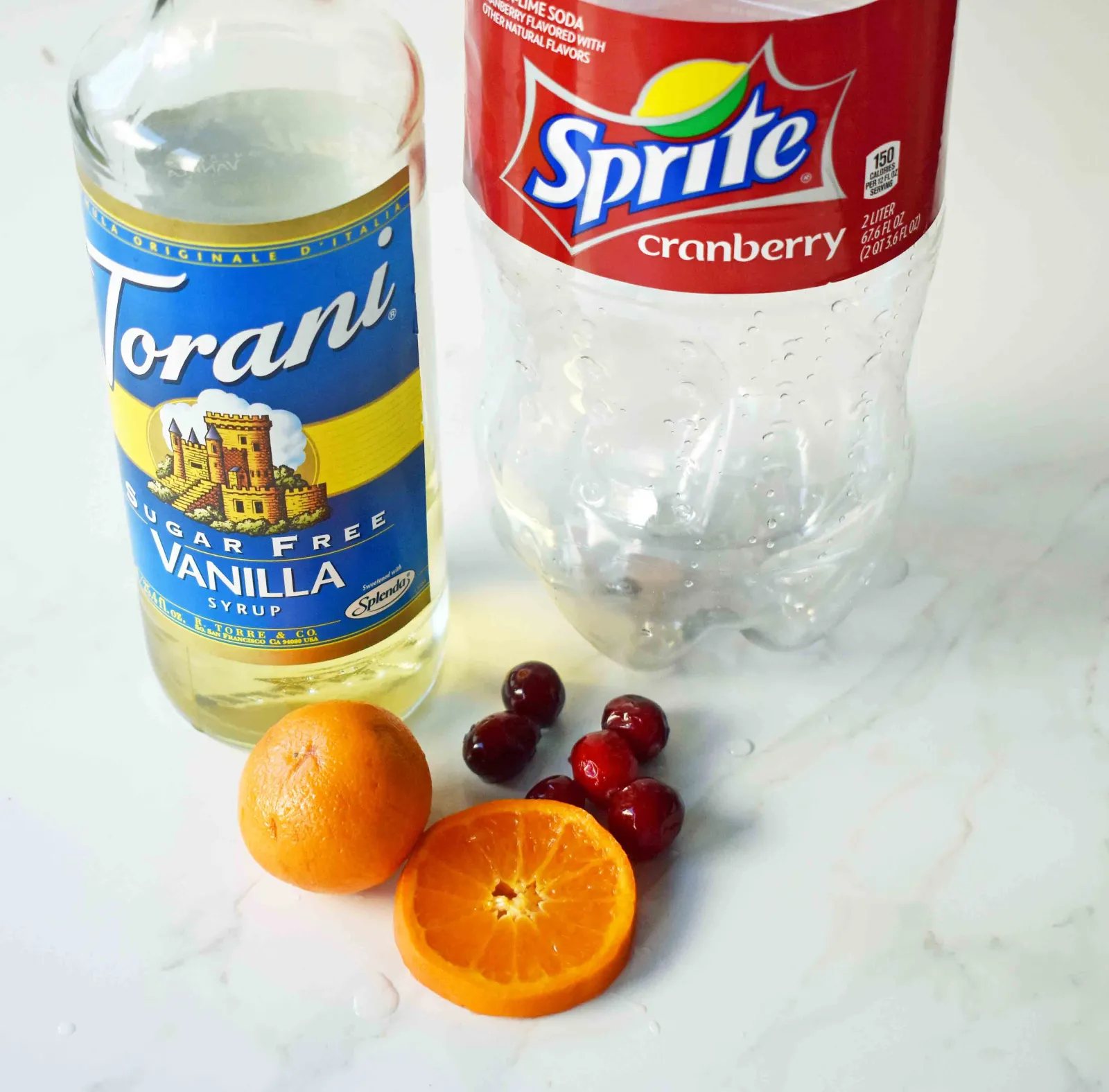 "The Henry" Cranberry Orange Mocktail by Modern Honey. Cranberry Sprite, Vanilla, Fresh Oranges and Cranberries. A perfect non-alcoholic party drink.
