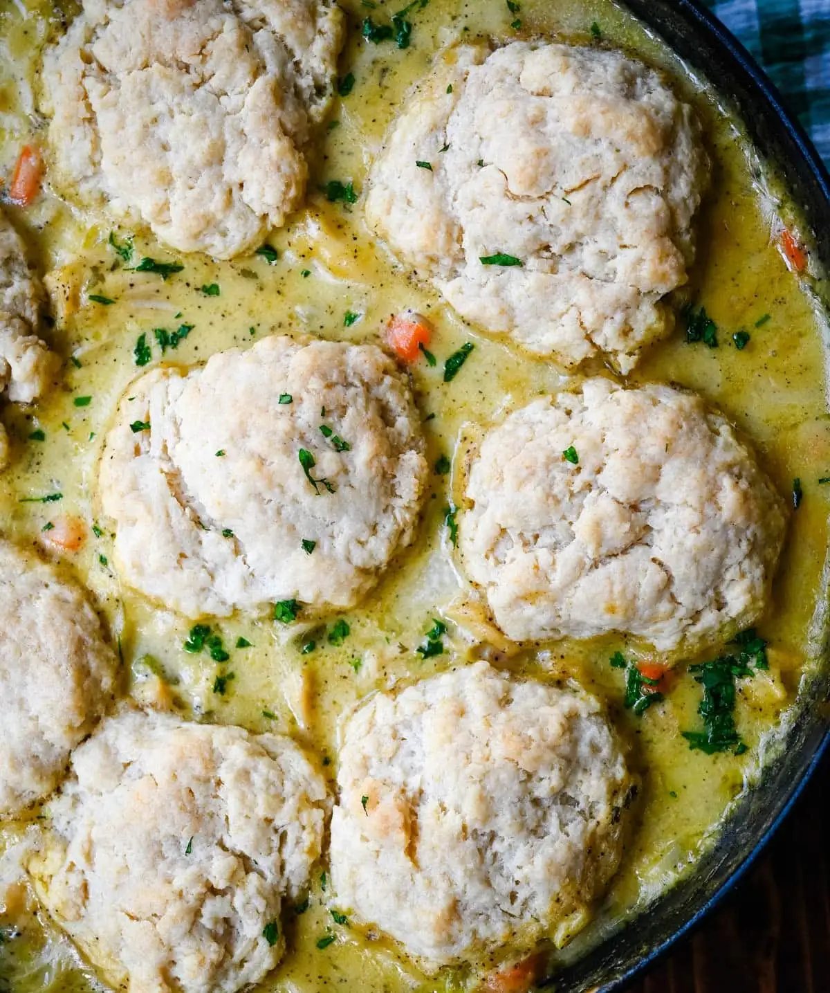 This homemade chicken cobbler is the from-scratch version of the viral casserole everyone has been making, with a rich, creamy chicken filling and buttery cheddar garlic drop biscuits baked right on top. No boxed biscuit mix. No canned cream of chicken soup. Just real ingredients and a one-pan dinner that tastes like you spent all afternoon on it.