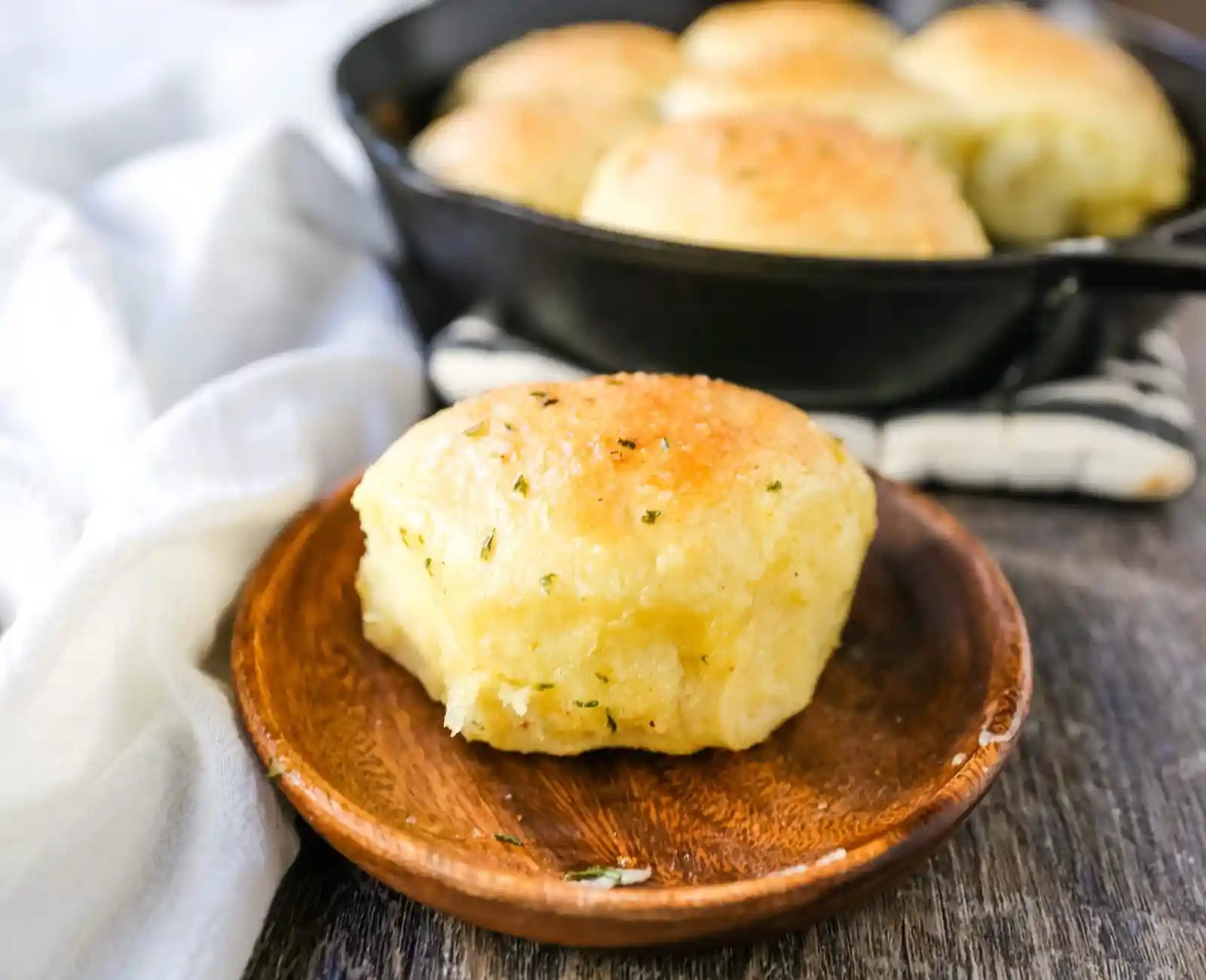 Homemade Garlic Butter Rolls. Made from scratch, fluffy homemade pull-apart rolls slathered in garlic herb butter. The perfect buttery homemade pull-apart rolls recipe! www.modernhoney.com #garlicbutterrolls #homemaderolls #rolls #dinnerrolls #pullapartrolls