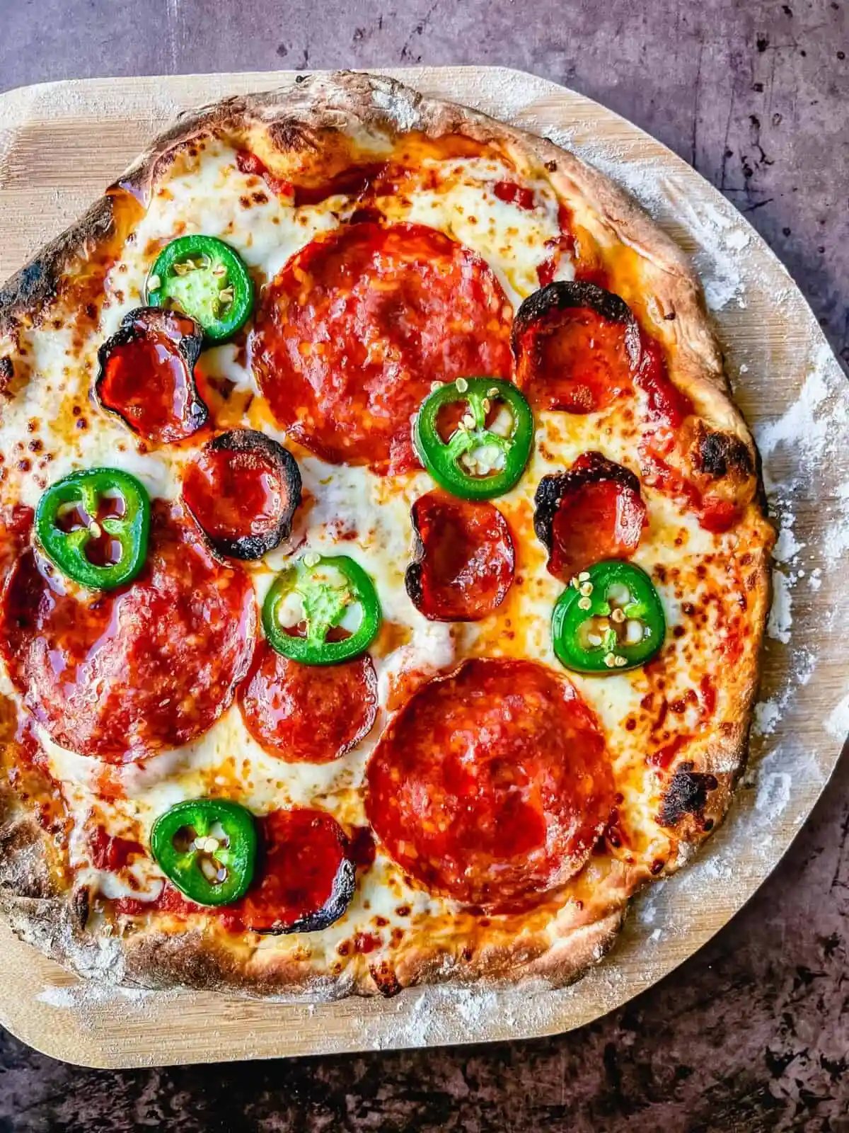 Homemade Pepperoni Jalapeno Hot Honey Pizza. Pepperoni Pizza with Hot Honey and Red Chili Flakes. How to make the best homemade pepperoni pizza at home with homemade pizza dough that makes the perfect crispy yet chewy crust. Tips and tricks for making gourmet pizza at home!