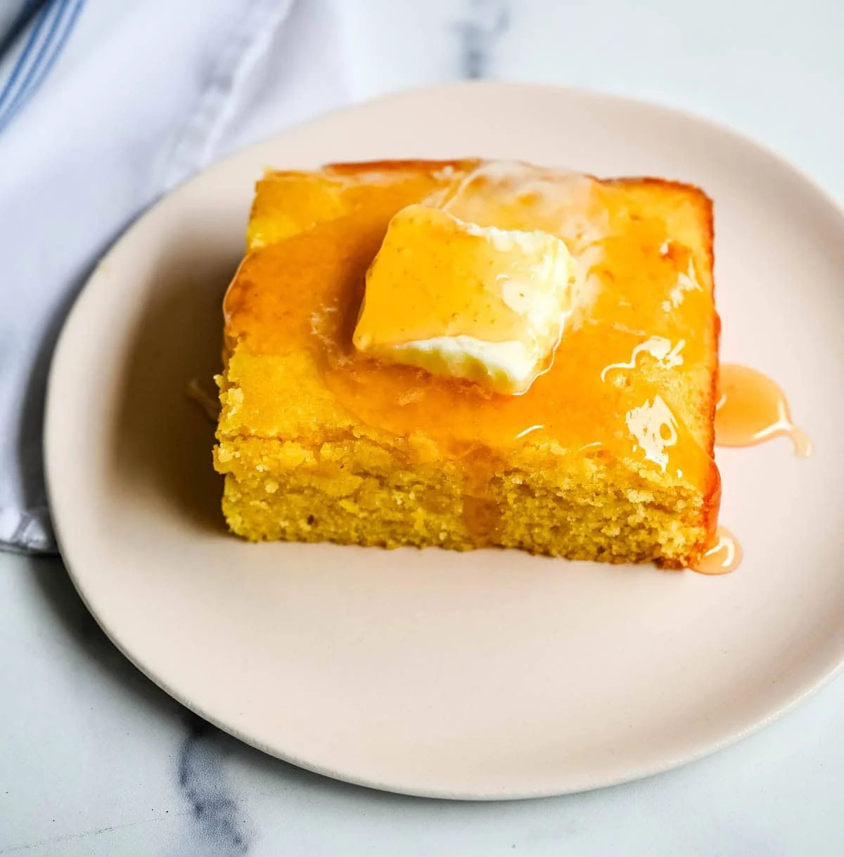 This moist and fluffy hot honey cornbread is sweet, slightly spicy, and absolutely packed with flavor from the very first bite! This is the most irresistible cornbread topped with hot honey butter you will ever make, and it comes together in just one bowl in under 30 minutes, making it the easiest and most flavorful side dish.