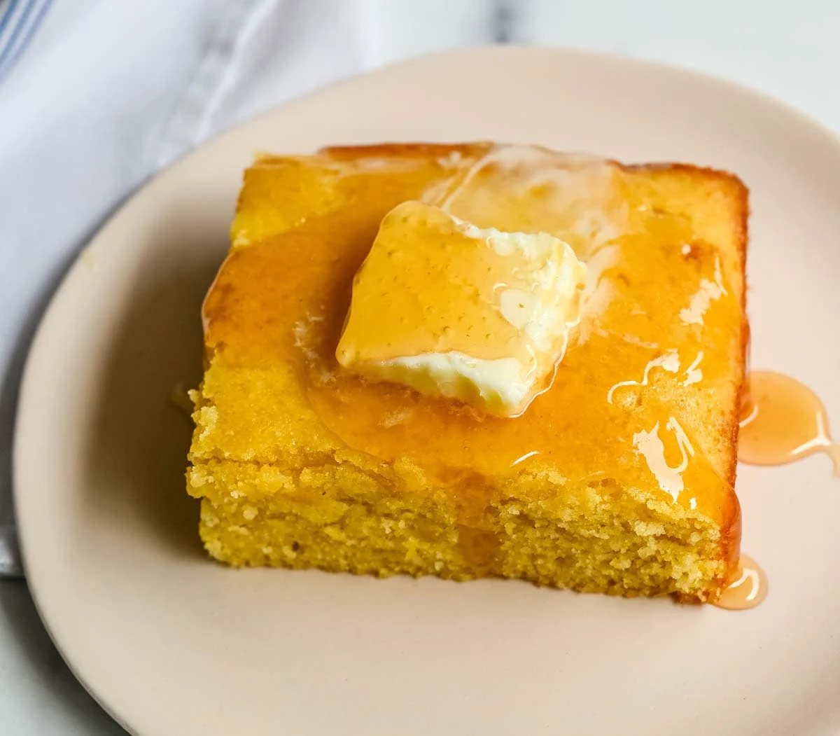 This moist and fluffy hot honey cornbread is sweet, slightly spicy, and absolutely packed with flavor from the very first bite! This is the most irresistible cornbread topped with hot honey butter you will ever make, and it comes together in just one bowl in under 30 minutes, making it the easiest and most flavorful side dish.