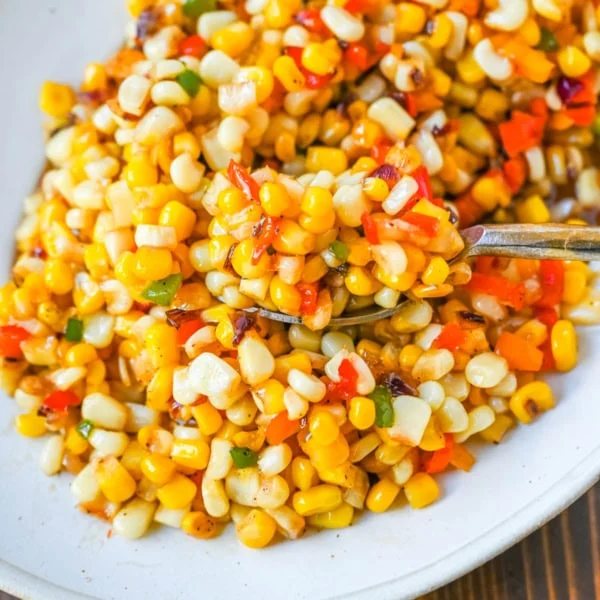 This Hot Honey Skillet Corn recipe is an easy and flavorful side dish made with sweet corn, peppers, onions, and spicy hot honey. It’s a quick corn recipe that's ready in under 20 minutes and pairs perfectly with roasted turkey or chicken.