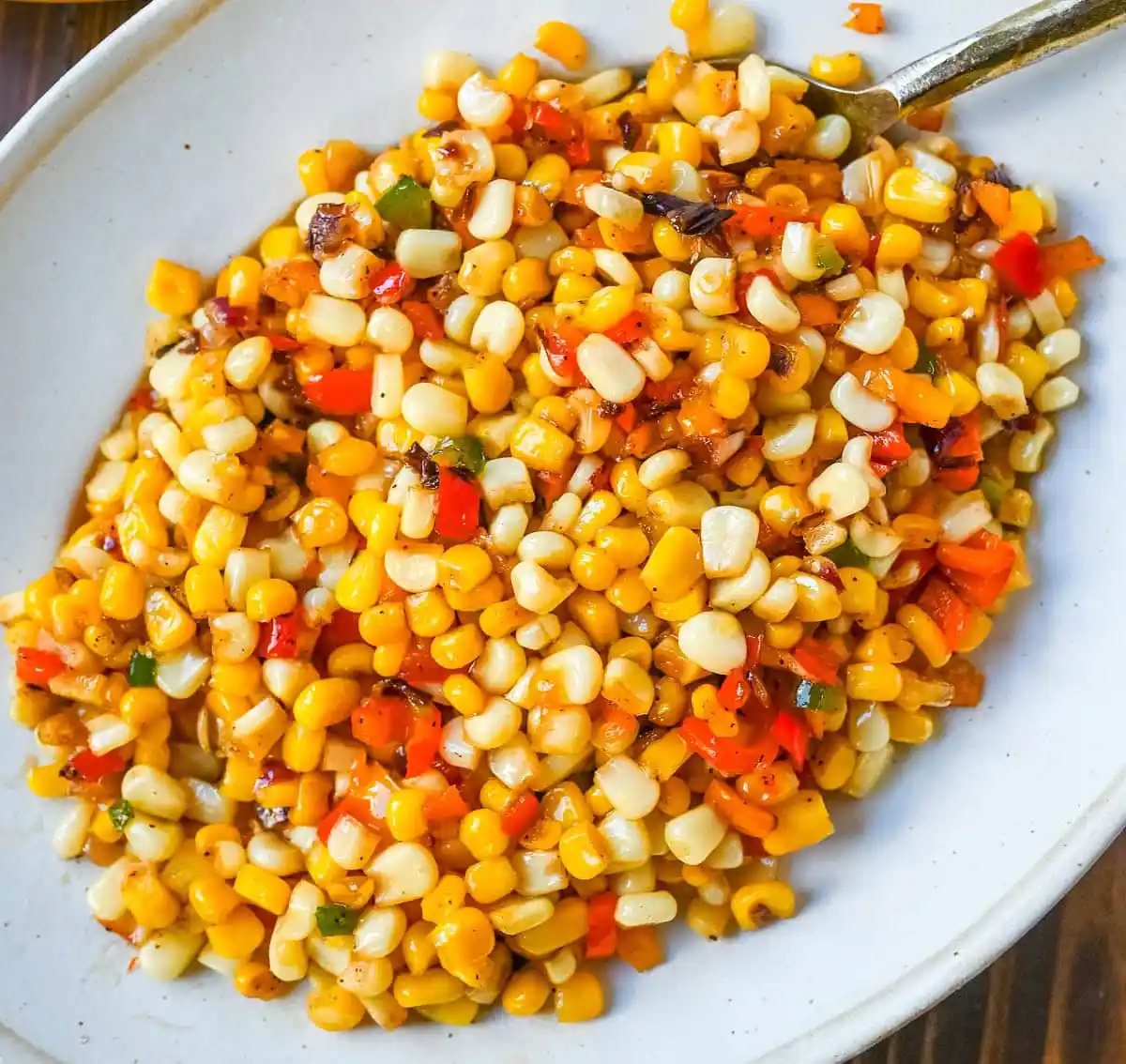 This Hot Honey Skillet Corn recipe is an easy and flavorful side dish made with sweet corn, peppers, onions, and spicy hot honey. It’s a quick corn recipe that's ready in under 20 minutes and pairs perfectly with roasted turkey or chicken.