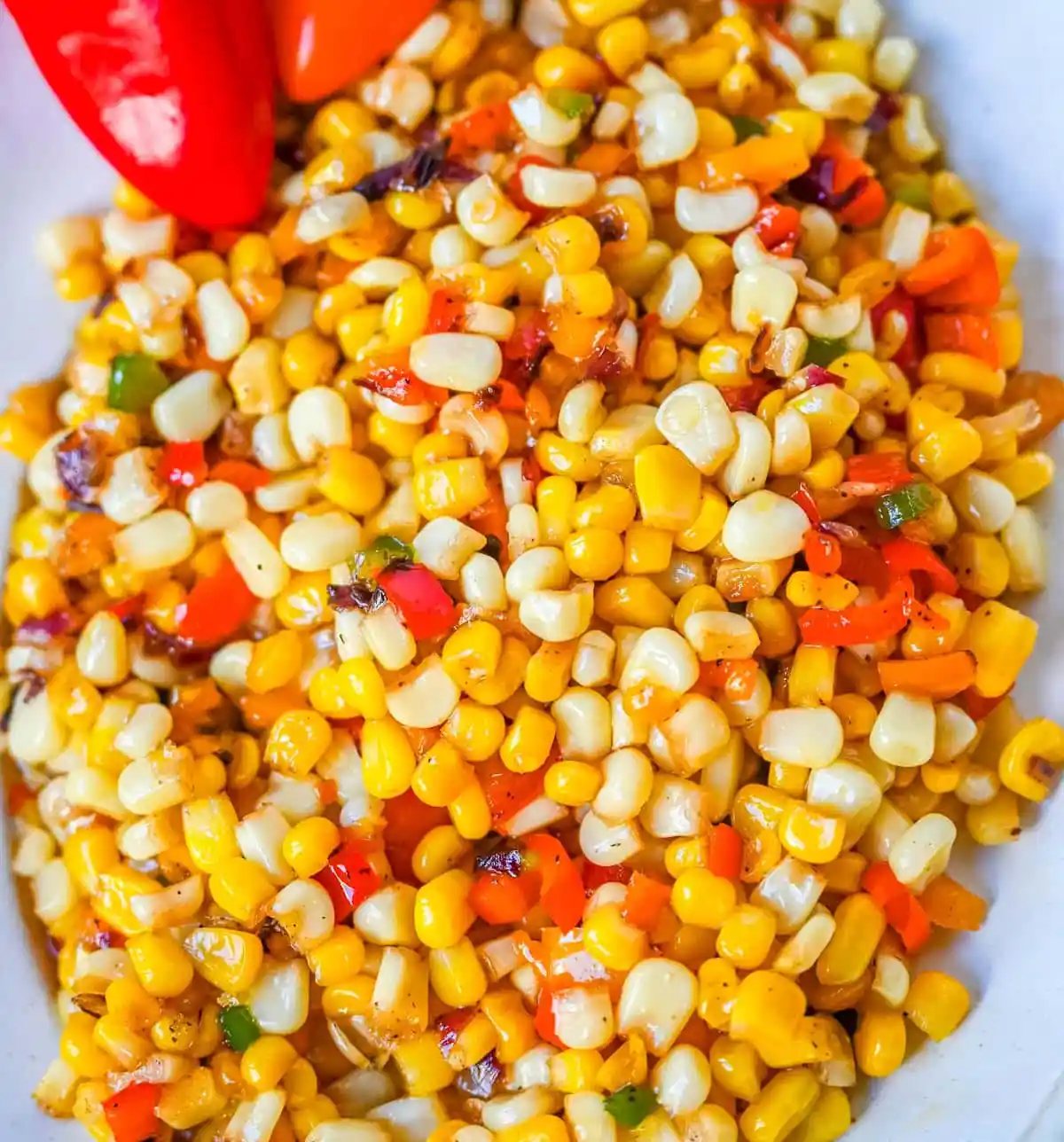 This Hot Honey Skillet Corn recipe is an easy and flavorful side dish made with sweet corn, peppers, onions, and spicy hot honey. It’s a quick corn recipe that's ready in under 20 minutes and pairs perfectly with roasted turkey or chicken.