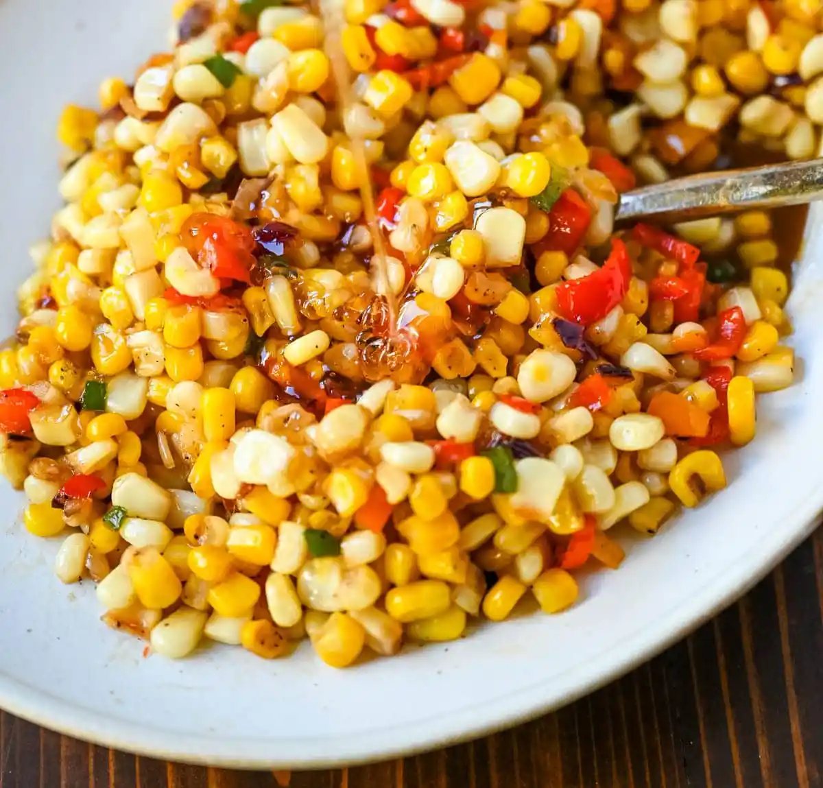 This Hot Honey Skillet Corn recipe is an easy and flavorful side dish made with sweet corn, peppers, onions, and spicy hot honey. It’s a quick corn recipe that's ready in under 20 minutes and pairs perfectly with roasted turkey or chicken.
