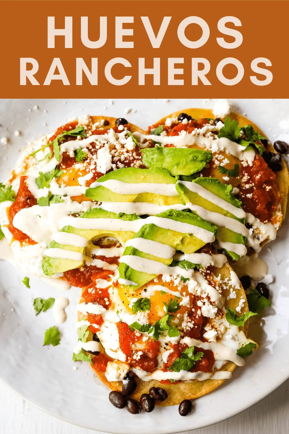 Huevos Rancheros. A traditional Mexican breakfast dish made with fried corn tortillas, fried egg, ranchera salsa, beans, avocado, cheese, and salsa. #huevosrancheros #mexican #mexicanfood #breakfast