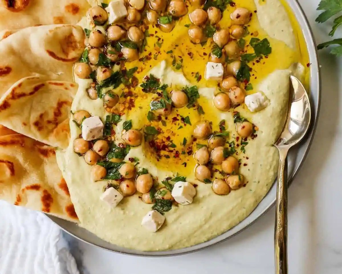 How to make authentic, creamy, homemade hummus made from scratch using simple ingredients -- chickpeas, tahini, garlic, olive oil, lemon juice, and salt. This is such an easy hummus recipe that everyone will love!