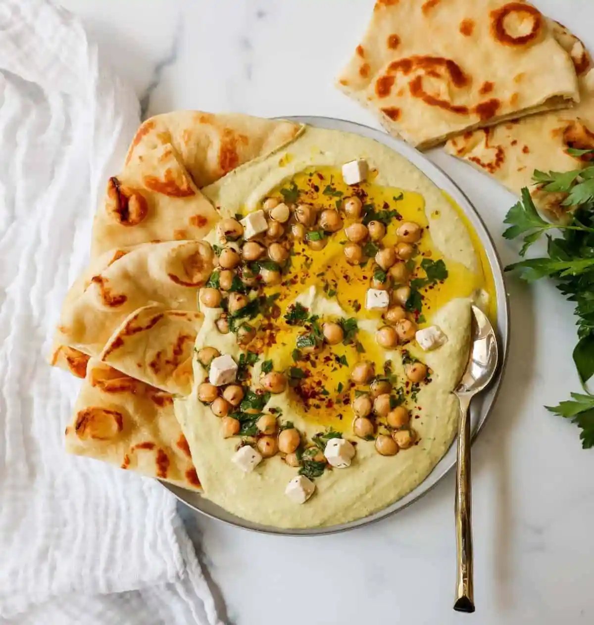 How to make authentic, creamy, homemade hummus made from scratch using simple ingredients -- chickpeas, tahini, garlic, olive oil, lemon juice, and salt. This is such an easy hummus recipe that everyone will love!