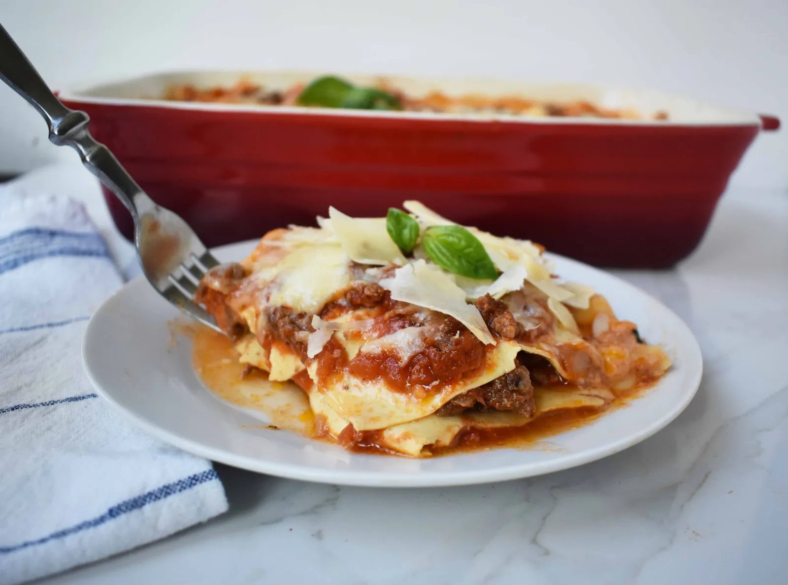 Italian Bolognese Lasagna. Authentic Italian recipe made with a traditional meat sauce, a creamy bechamel sauce, parmesan and mozzarella cheeses.