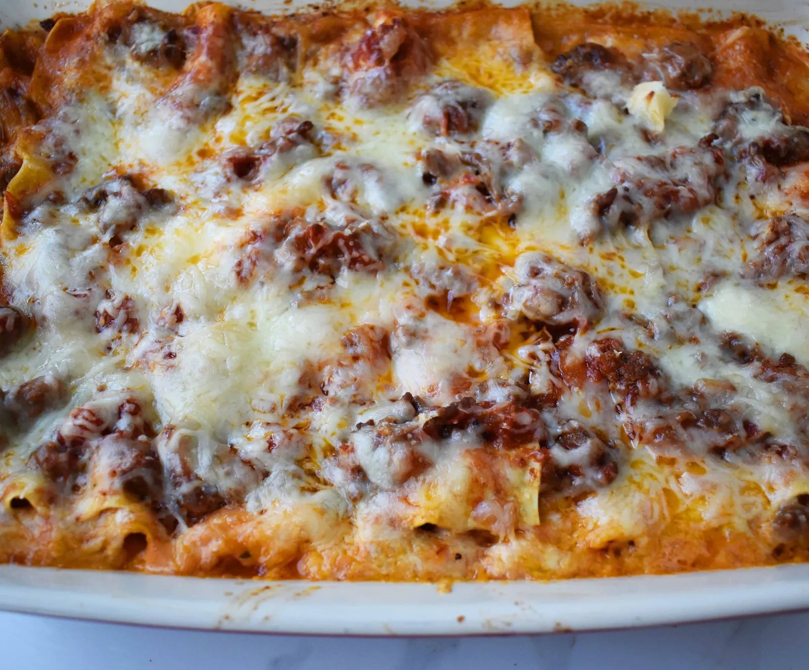 Italian Bolognese Lasagna. Authentic Italian recipe made with a traditional meat sauce, a creamy bechamel sauce, parmesan and mozzarella cheeses.