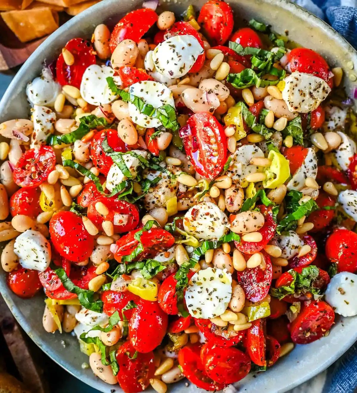 This Italian Cowboy Caviar is a fresh, flavorful twist on the viral cowboy caviar made with juicy tomatoes, creamy mozzarella pearls, tender white beans, pepperoncinis, and basil for a Mediterranean-inspired dip. This easy Italian appetizer comes together in minutes and is perfect for holiday parties, snacking, or meal prep.