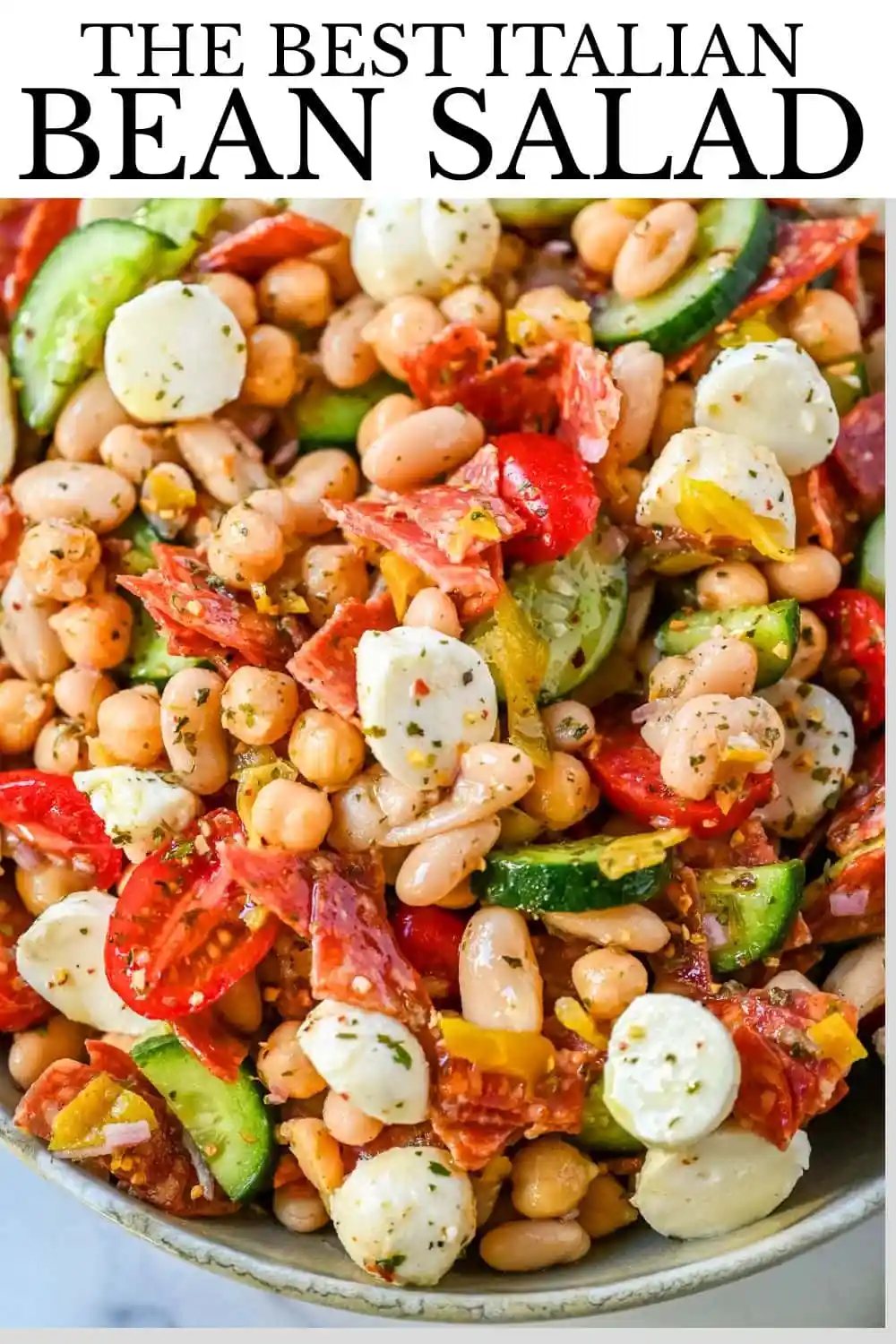 This Italian dense bean salad is the TikTok viral high protein meal prep recipe that has taken over the internet and for very good reason. Loaded with chickpeas, white beans, crisp Persian cucumbers, cherry tomatoes, creamy mozzarella, savory pepperoni or salami, and tangy pepperoncinis all tossed in a homemade Italian dressing, every single bite is packed with incredible flavor that gets better the longer it sits.