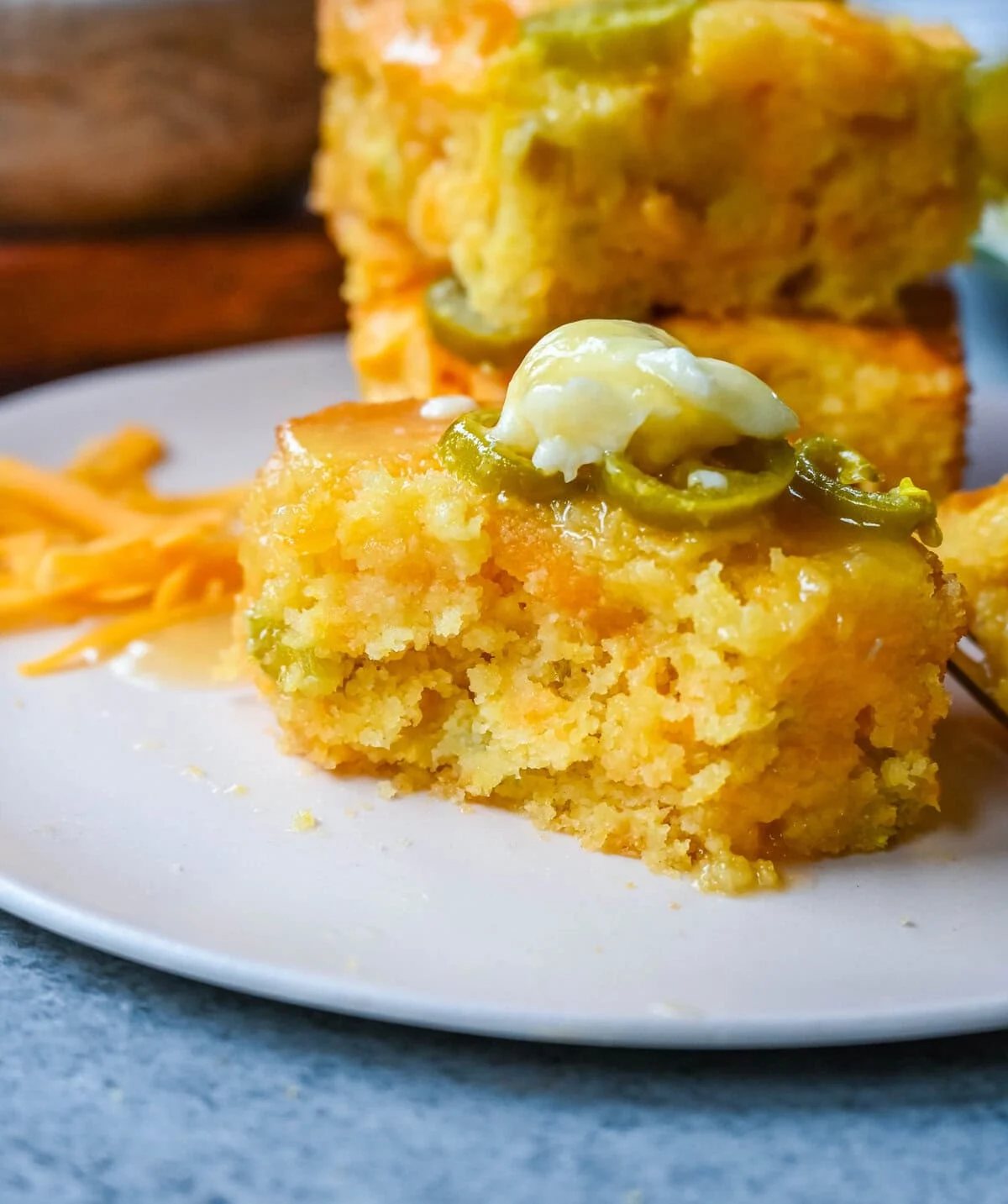 This Homemade Jalapeno Cheddar Cornbread is golden, cheesy, spicy, and just a little sweet, and is the ultimate upgrade from basic boxed cornbread. It has a moist, fluffy center amd layered with sharp cheddar cheese and jalapenos for the perfect Jalapeno Cheddar Cornbread recipe.